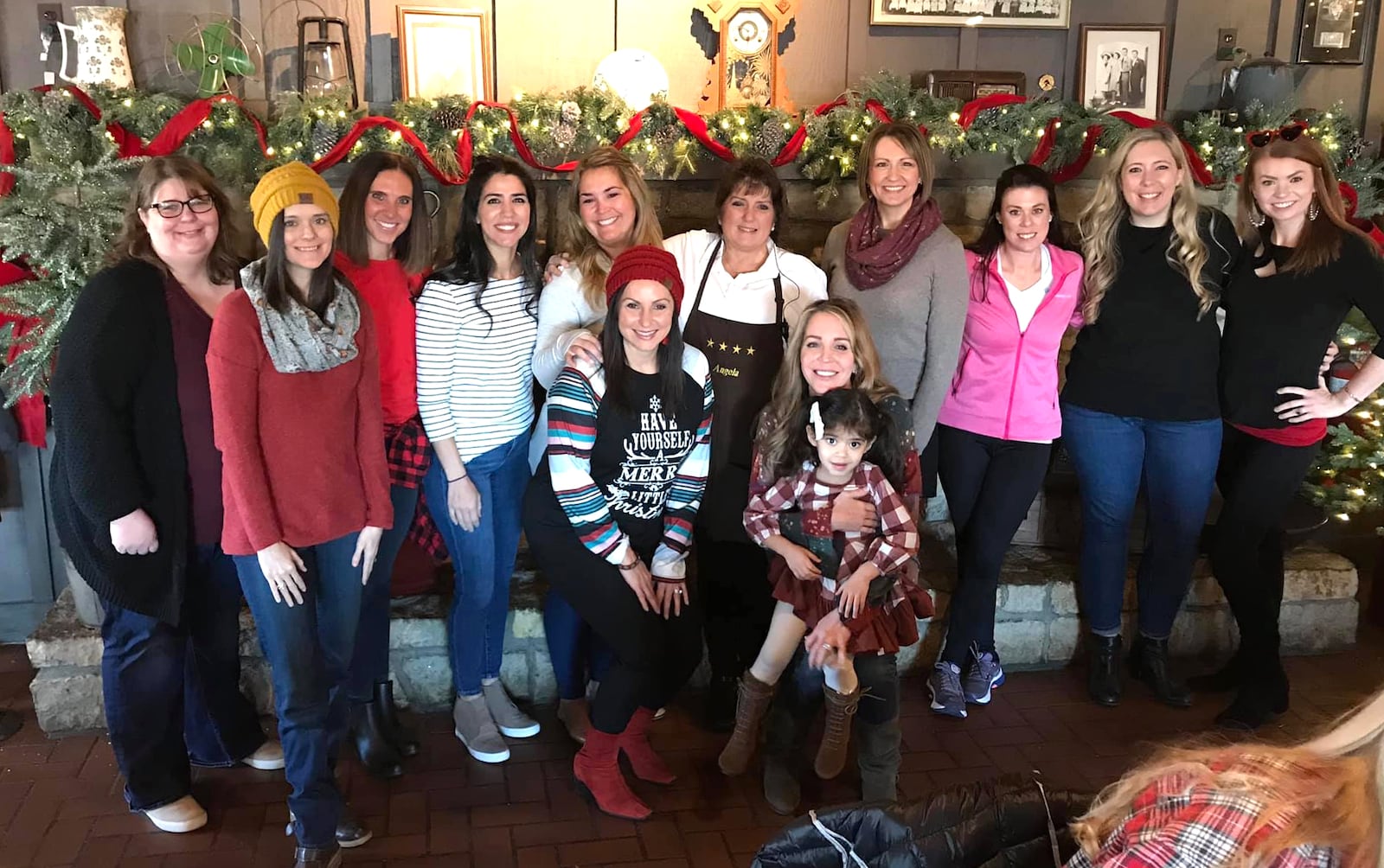 Angela Fuller of West Carrolton, (center) a waitress at Cracker Barrel on Wilmington Pike, was visited by a group of "Breakfast Santas" organized by Monica Deal of Centerville. The group of 11 women left Fuller a $1,000 tip. CONTRIBUTED PHOTO