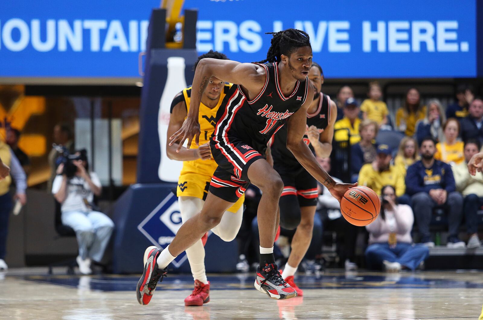 Houston forward Joseph Tugler runs up court against West Virginia during the second half of an NCAA college basketball game, Wednesday, Jan. 29, 2025, in Morgantown, W.Va. (AP Photo/Kathleen Batten)