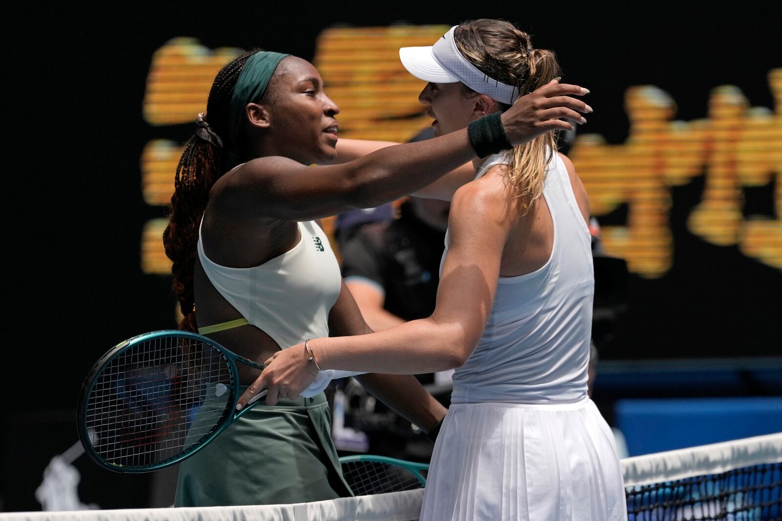 Paula Badosa of Spain is congratulated by Coco Gauff, left, of the U.S. following their quarterfinal match at the Australian Open tennis championship in Melbourne, Australia, Tuesday, Jan. 21, 2025. (AP Photo/Ng Han Guan)