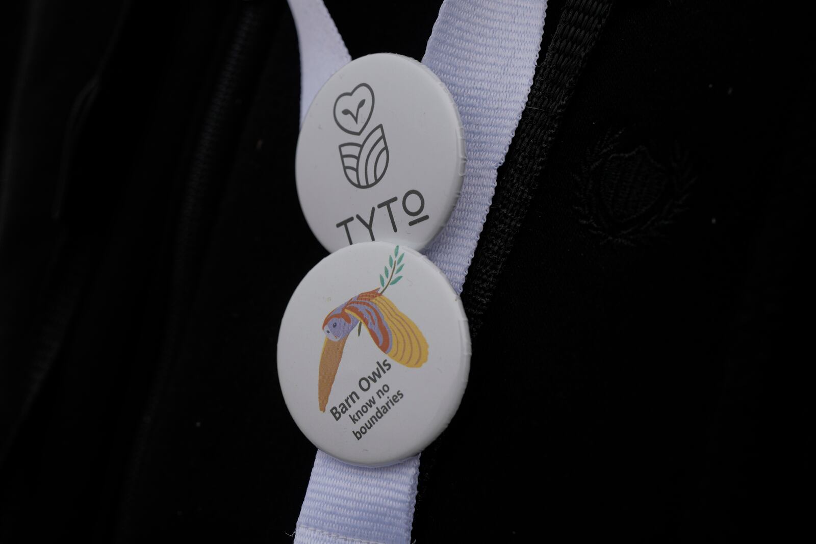 A birdwatcher wears pins for barn owls, and the Greek environmental group TYTO as Karla lake , near the town of Stefanovikeio, Larissa, central Greece, on Jan. 22, 2025. (AP Photo/Petros Giannakouris)