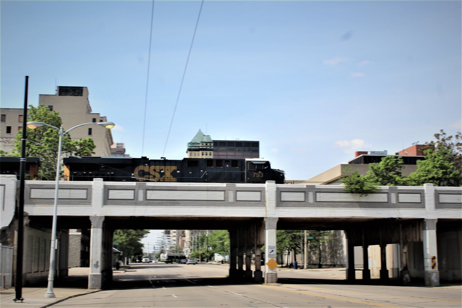 A CSX commercial train crosses an overpass on South Main Street in downtown Dayton. Dayton hasn't had passenger rail since 1979. CORNELIUS FROLIK / STAFF