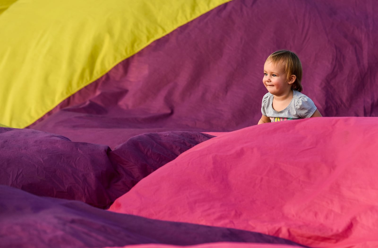 This little lady walks on a partially inflated balloon during the Fluff & Puff event at the 2016 Ohio Challenge Hot Air Balloon Festival at Smith Park in Middletown. NICK GRAHAM/STAFF