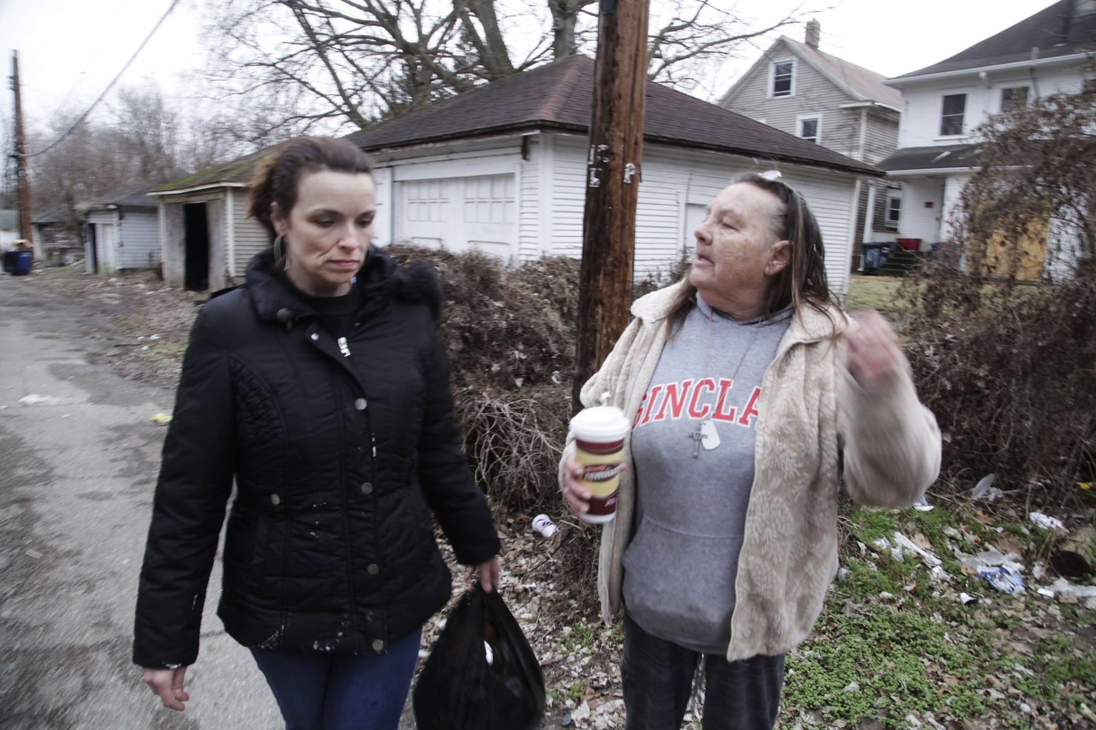 Victoria McNeal, president of the Riverdale Neighborhood Association and fellow neighborhood activist Lynn LaMance, of the Five Oaks neighborhood, patrol the alley between W. Hudson and Marathon streets in Dayton. The two women pick up trash, report open vacant structures, paint over graffiti and try to get property owners to take care of their property. STAFF Byron Stirsman