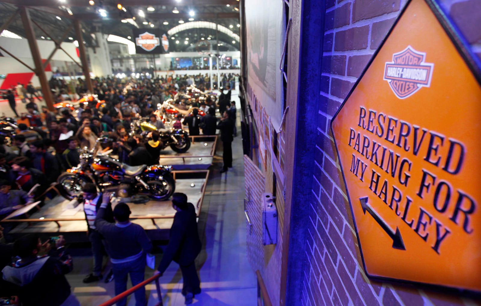 Indians crowd around Harley Davidson motorcycles at their stall during Auto Expo in New Delhi, India, Jan. 7, 2012. (AP Photo/Mustafa Quraishi)