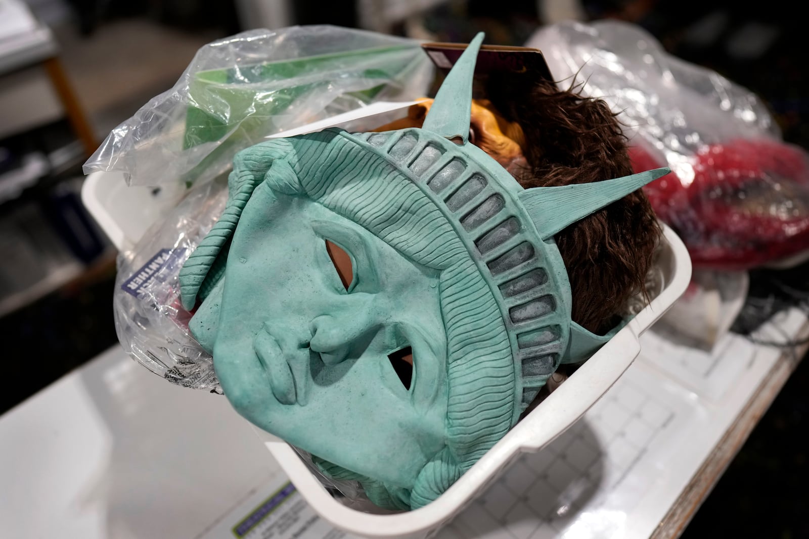 Masks sit in a basket at The Theatrical Shop, Tuesday, Oct. 29, 2024, in West Des Moines, Iowa. (AP Photo/Charlie Neibergall)