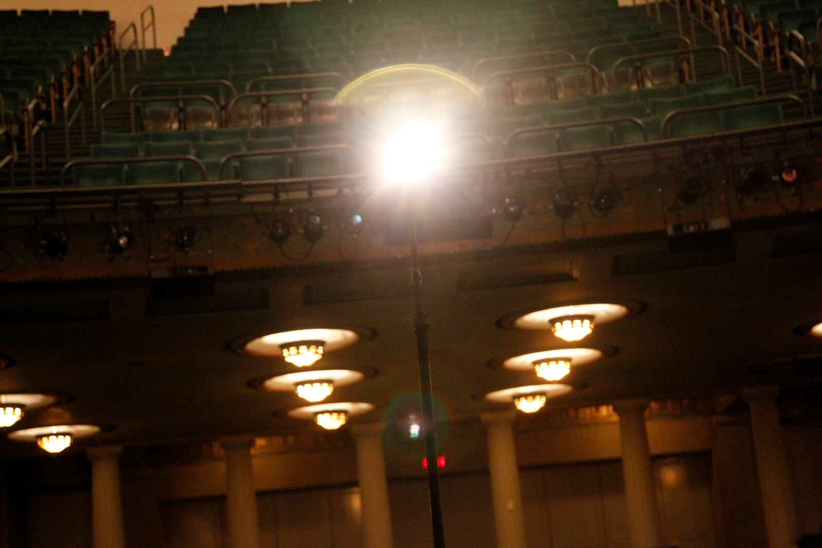 A ghost light placed at the center of the stage keeps the empty Victoria Theatre illuminated. LISA POWELL / STAFF