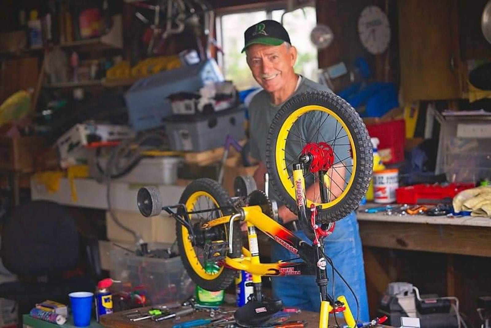 Charlie Gau works on a bike in West Carrollton. Gau was nominated as a Community Gem for the work he does repairing bikes and giving bikes to children and adults in the Dayton-area. CONTRIBUTED