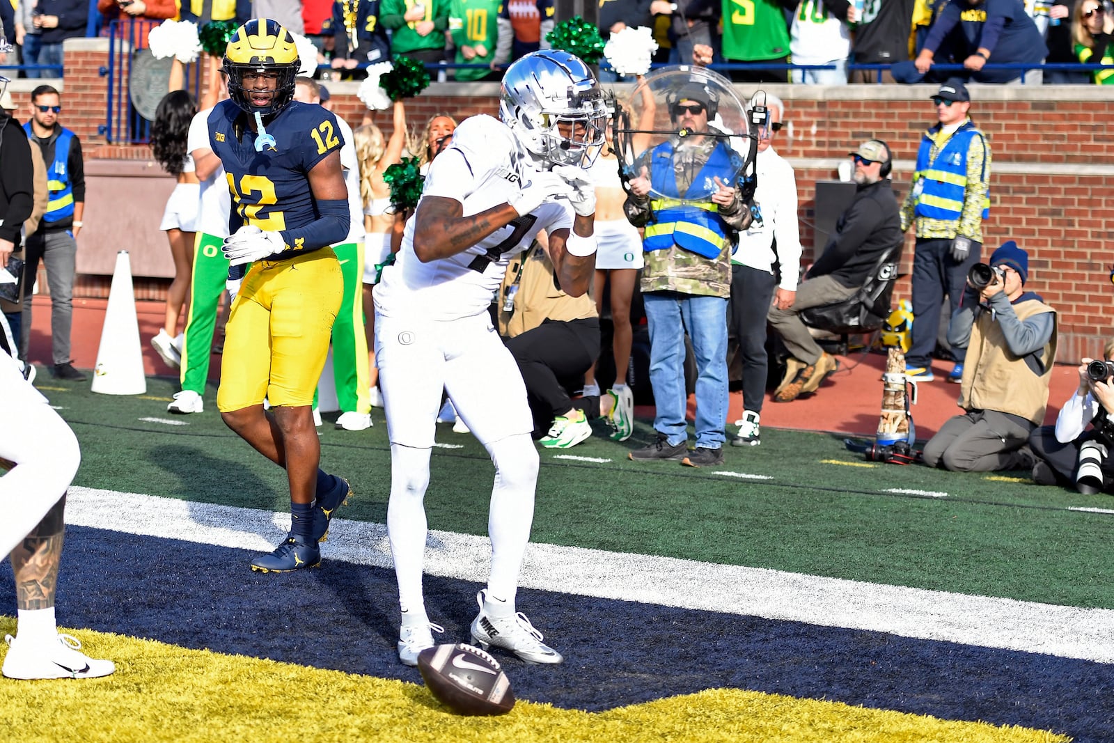 Oregon wide receiver Evan Stewart, right, reacts after scoring a touchdown as Michigan defensive back Aamir Hall looks on during the first half of an NCAA college football game, Saturday, Nov. 2, 2024, in Ann Arbor, Mich. (AP Photo/Jose Juarez)