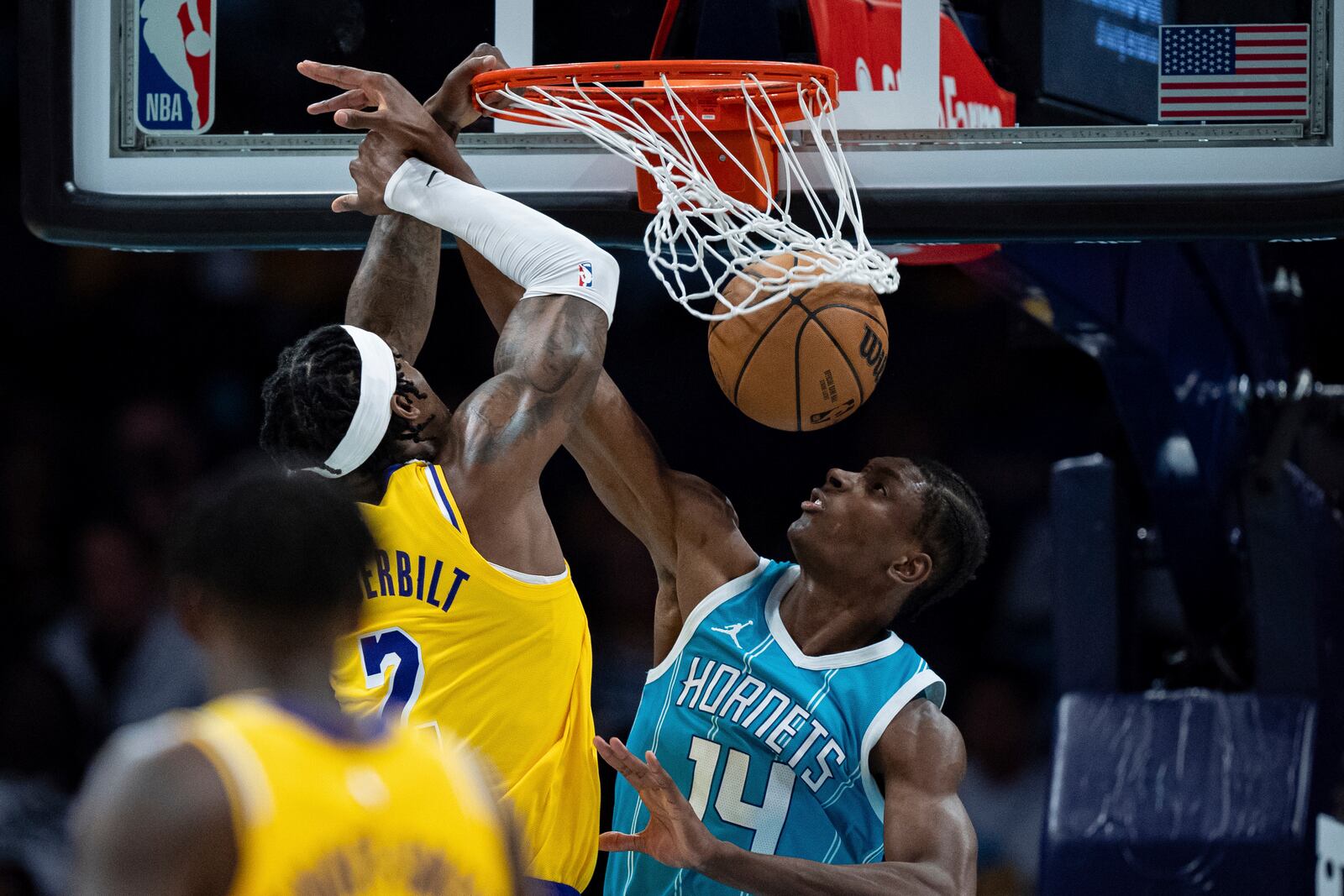 Los Angeles Lakers forward Jarred Vanderbilt, top left, dunks over Charlotte Hornets forward Moussa Diabate (14) during the first half of an NBA basketball game Monday, Jan. 27, 2025, in Charlotte, N.C. (AP Photo/Jacob Kupferman)