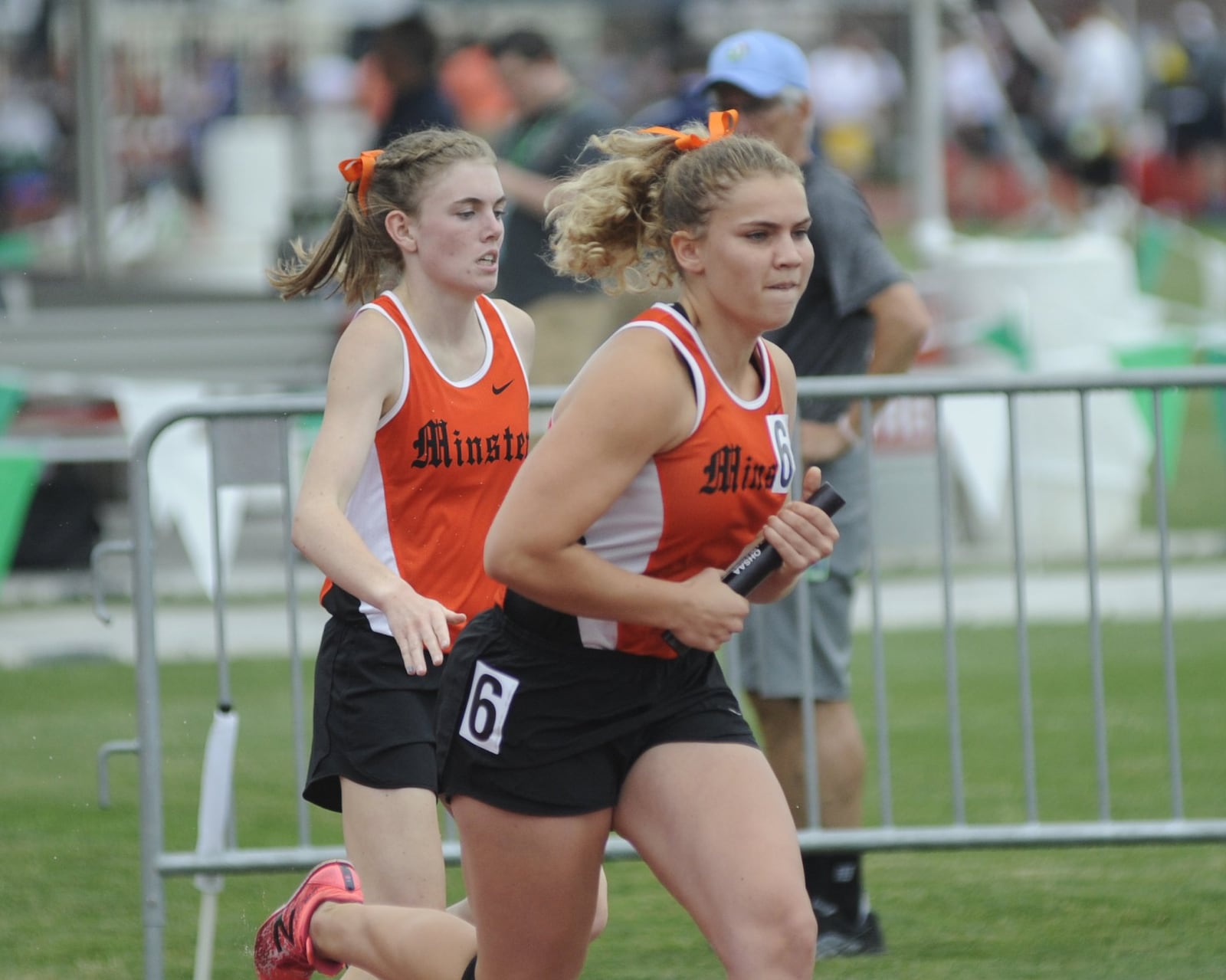 Minster anchor Madeline Magoto (right) takes off after a 4x800 relay baton exchange from Emma Watcke during the D-III state track and field meet in Columbus on Friday, June 1, 2018. MARC PENDLETON / STAFF