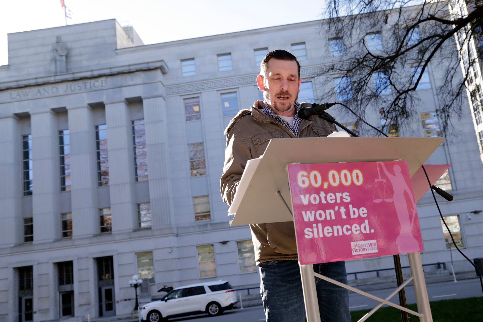 Ted Corcoran reads names from a list of over 60,000 people who cast ballots in the November 2024 election but whose votes have been challenged by Republican state Supreme Court candidate Jefferson Griffin in his extremely close race with Demcoratic Associate Justice Allison Riggs, Tuesday, Jan. 14, 2025, in Raleigh, N.C. Behind him is the North Carolina Supreme Court. (AP Photo/Chris Seward)