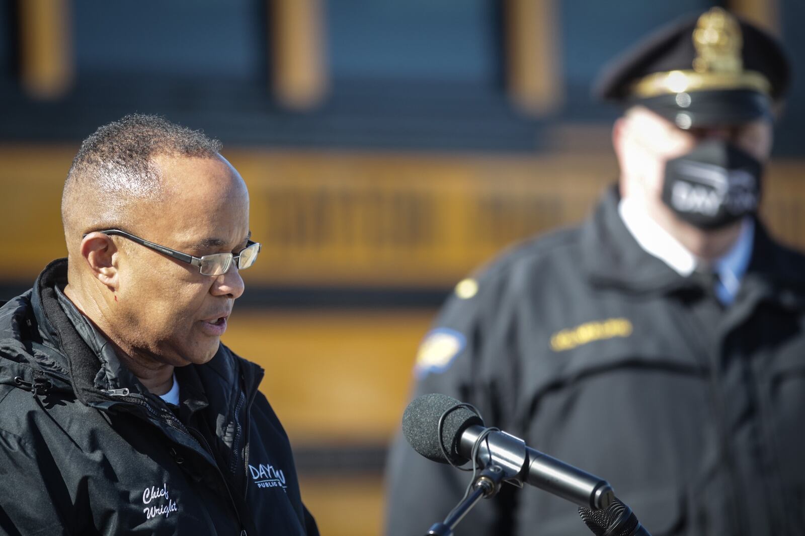 DPS Chief of Safety, Richard Wright II, left and Dayton Police Lt. James Mullins talked to the media Tuesday morning at Dunbar High School about Dayton students' return to in-person school next week.