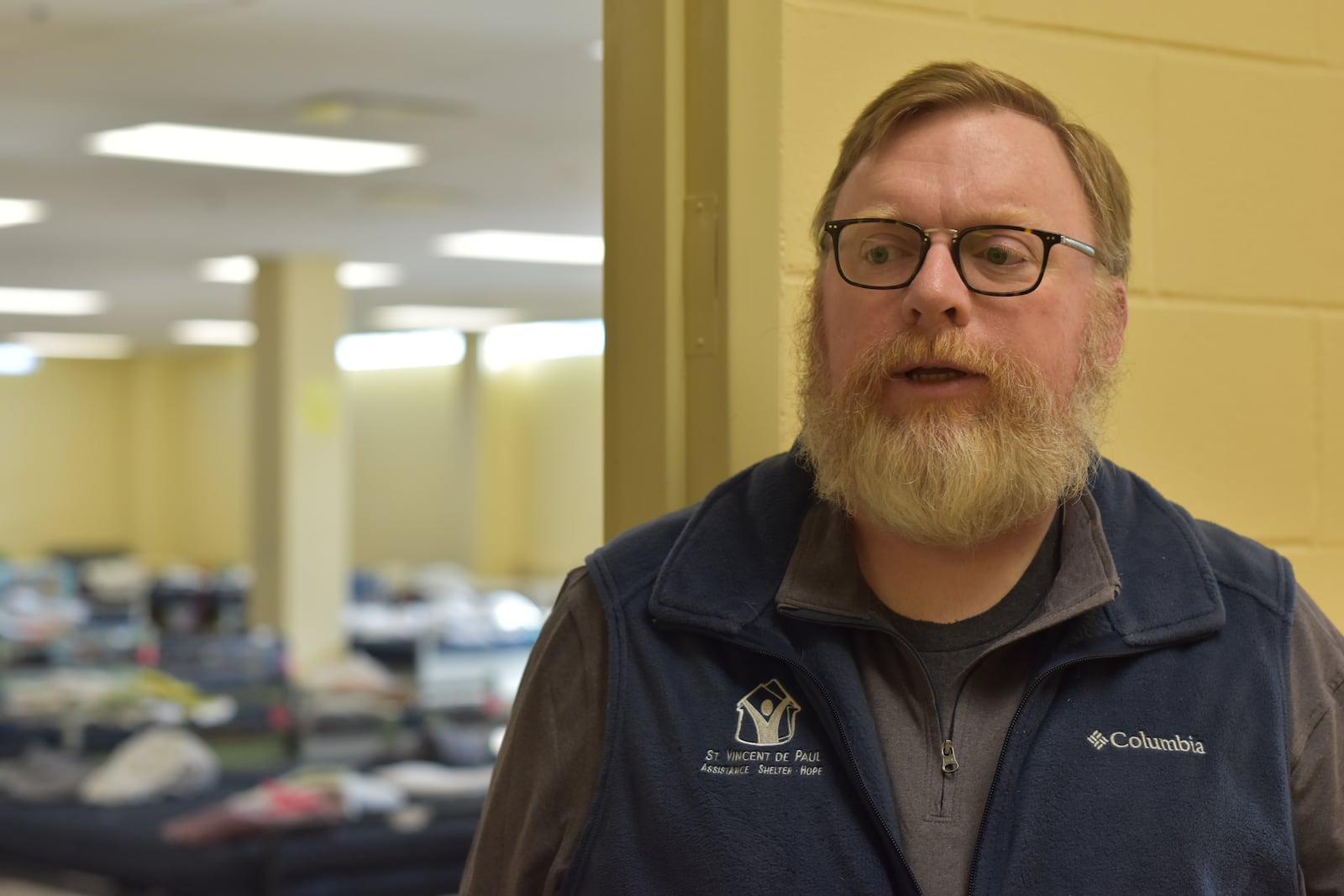 Michael Vanderburgh, executive director, St. Vincent de Paul Society, Dayton. Behind him is one of the dorms at the homeless shelter for women and families. CORNELIUS FROLIK / STAFF