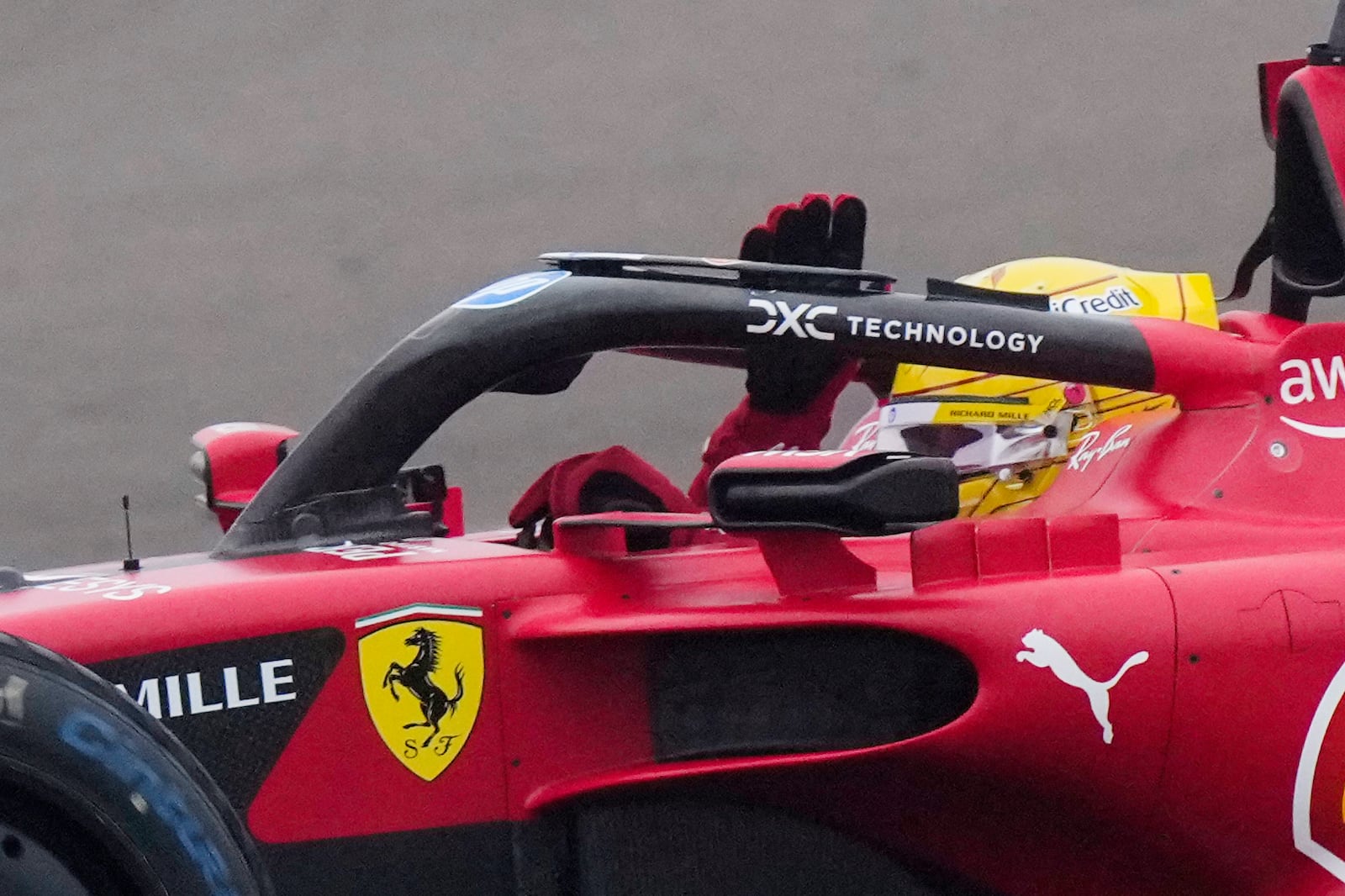 British driver Lewis Hamilton waves to fans during the first lap with a Ferrari Formula One SF-23 at the Ferrari private test track, in Fiorano Modenese, Italy, Wednesday, Jan.22, 2025. (AP Photo/Luca Bruno)