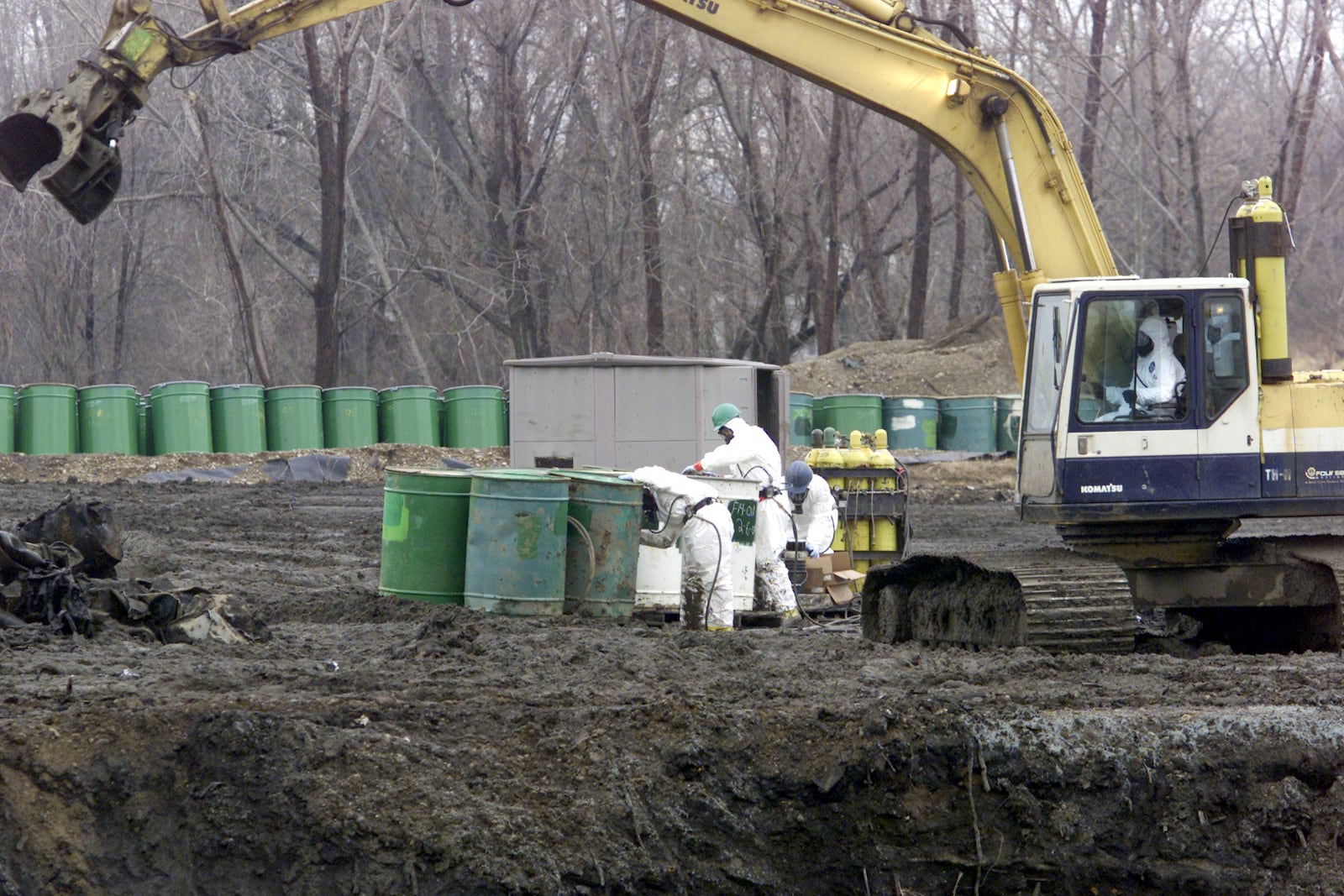 In this 2018 file photo, workers for the federal Environmental Protection Agency pack up barrels of hazardous waste from the Valleycrest Landfill in Dayton, while wearing protective suits.