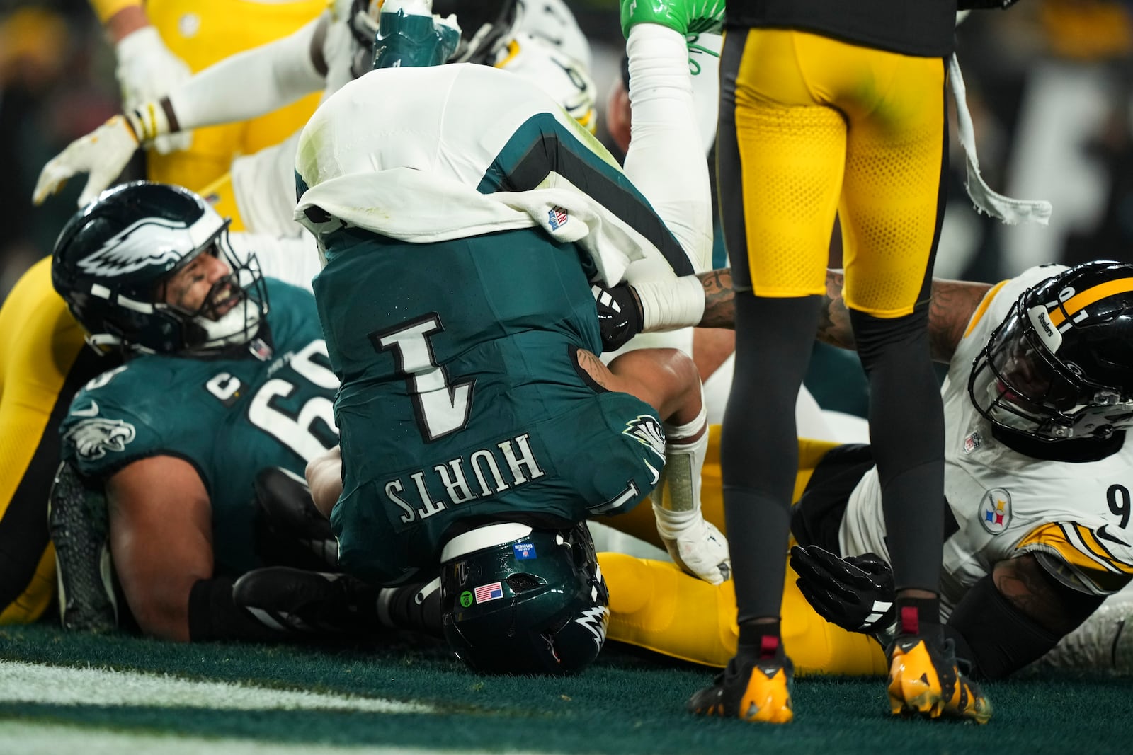 Philadelphia Eagles quarterback Jalen Hurts (1) scores a touchdown during the second half of an NFL football game against the Pittsburgh Steelers on Sunday, Dec. 15, 2024, in Philadelphia. (AP Photo/Matt Slocum)