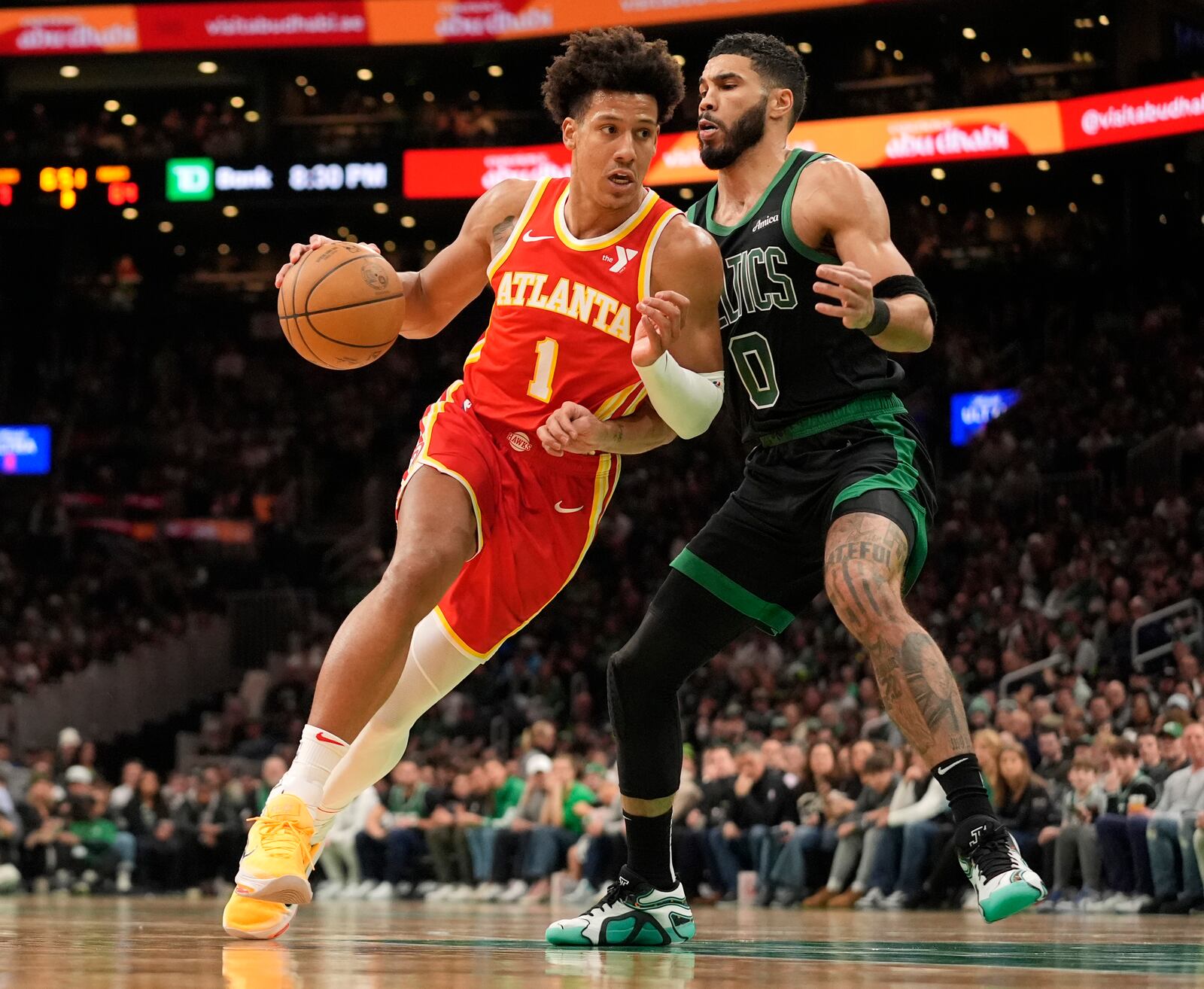 Atlanta Hawks' Jalen Johnson (1) drives by Boston Celtics' Jayson Tatum (0) during the second half of an NBA basketball game, Saturday, Jan. 18, 2025, in Boston. (AP Photo/Robert F. Bukaty)