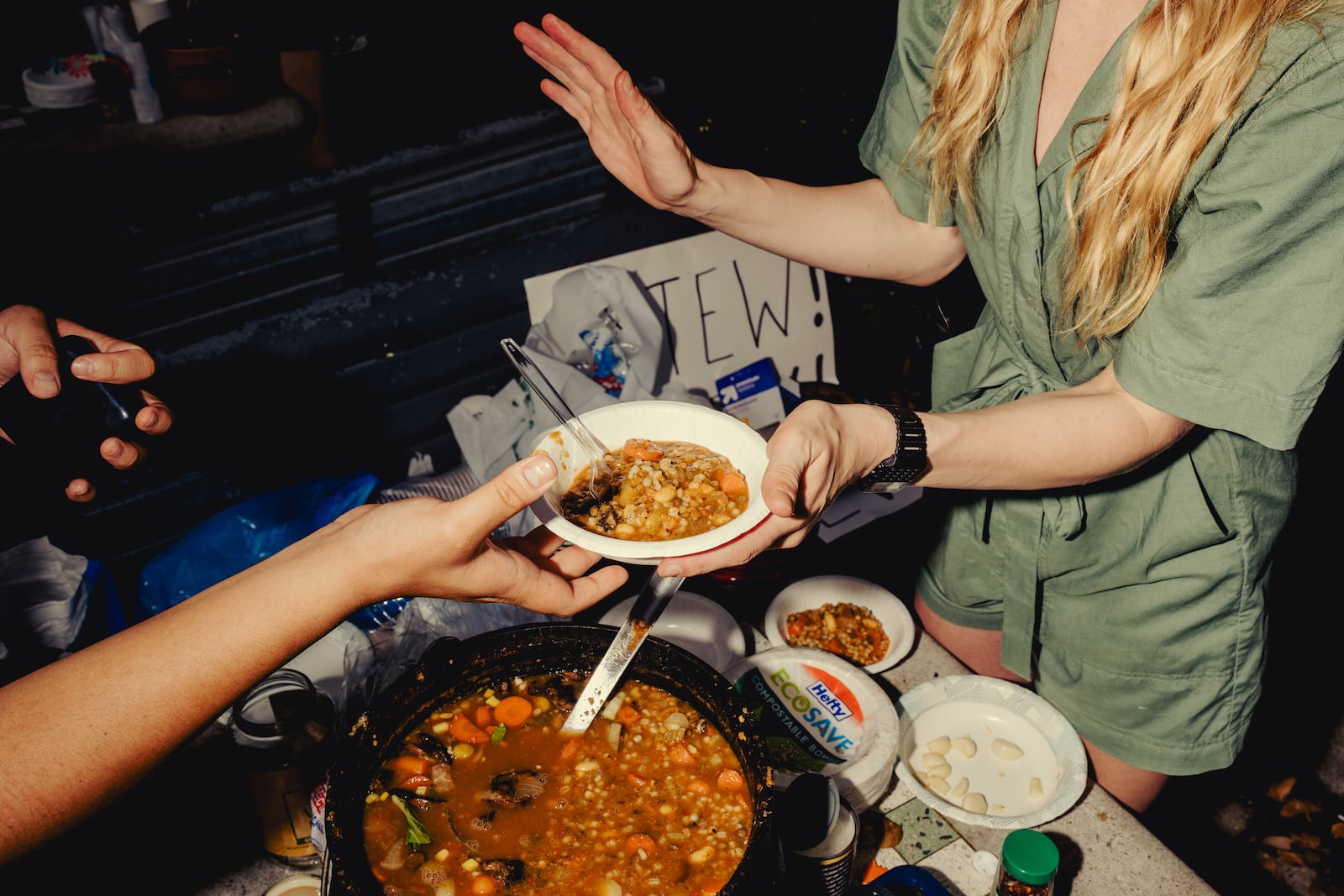 
                        FILE — Annie Rauwerda serves her “perpetual stew” at Fermi Playground in Bushwick, Brooklyn, July 18, 2023. The writer and comedian Annie Rauwerda stirred up a big reaction on the internet — and in her Brooklyn neighborhood — when she cooked a pot of vegan stew for over a month this summer. (Amir Hamja/The New York Times)
                      