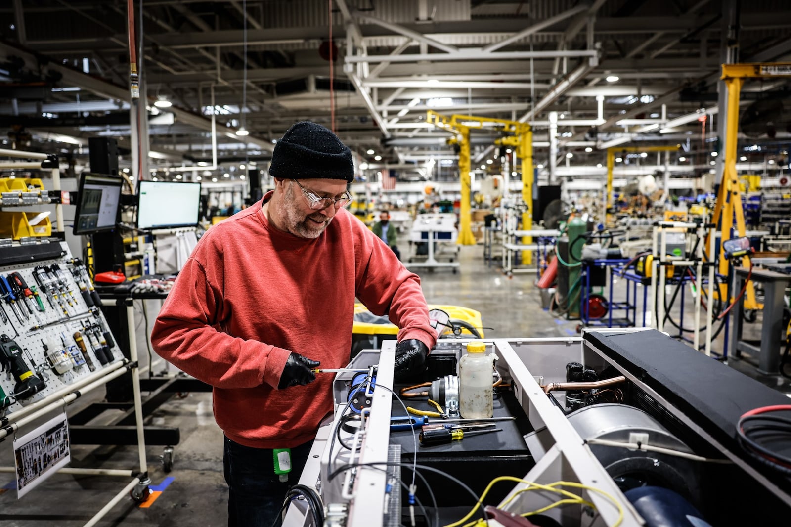 Phil Lyndower builds a HVAC for freight train engines at the Dayton Phoenix Group. JIM NOELKER/STAFF