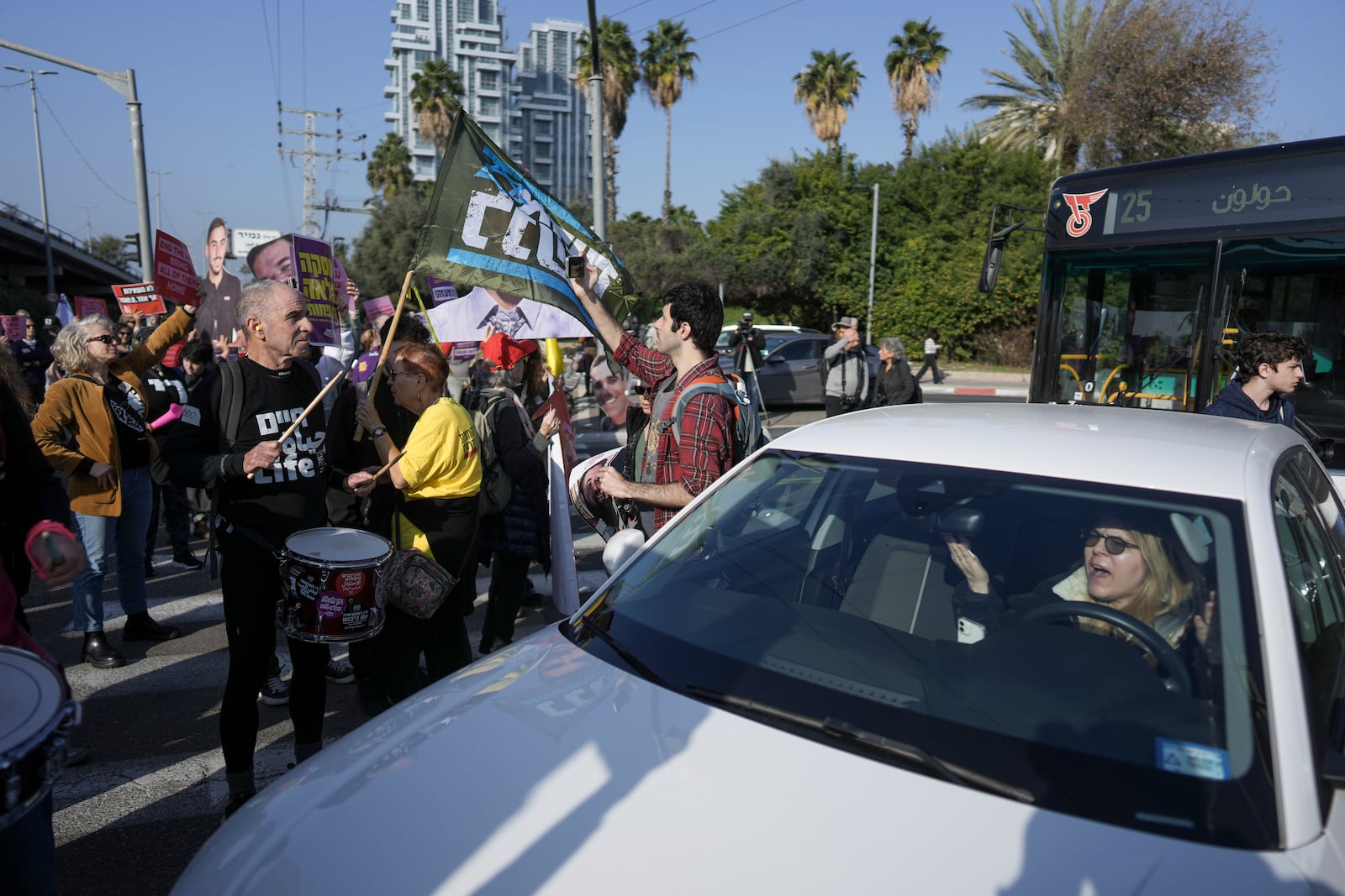 Relatives and supporters of Israelis held hostage in the Gaza Strip, block a freeway during a protest demanding their release from Hamas captivity as they mark 500 days of the Israel-Hamas war in Tel Aviv, Israel, Monday, Feb. 17, 2025. (AP Photo/Oded Balilty)