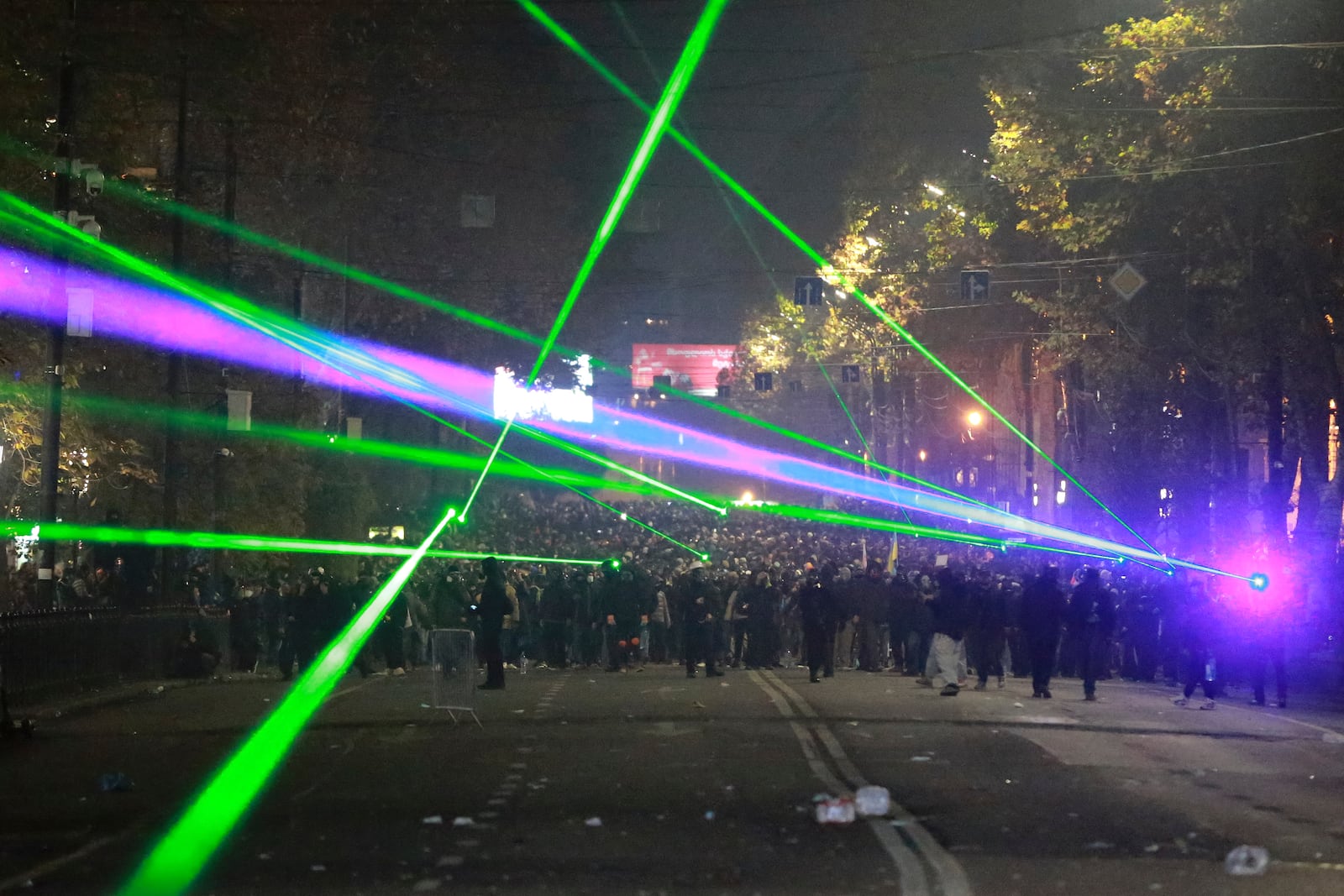 Demonstrators use lasers towards the police during a rally outside the parliament to protest against the government's decision to suspend negotiations on joining the European Union in Tbilisi, Georgia, on Tuesday, Dec. 3, 2024. (AP Photo/Zurab Tsertsvadze)