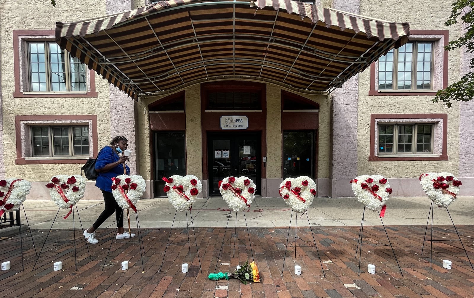 A women walks by a makeshift memorial of the nine people who where killed two years ago today in the Oregon District mass shooting in Dayton, Ohio. Jim Noelker/Staff