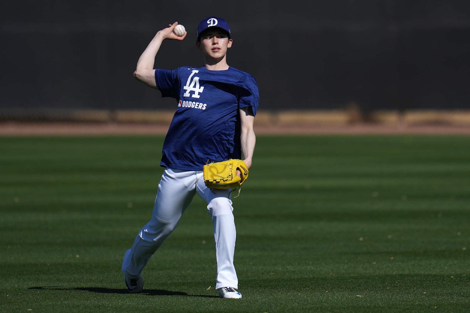 Los Angeles Dodgers pitcher Roki Sasaki, of Japan, warms up at the Dodgers baseball spring training facility, Tuesday, Feb. 11, 2025, in Phoenix. (AP Photo/Ross D. Franklin)