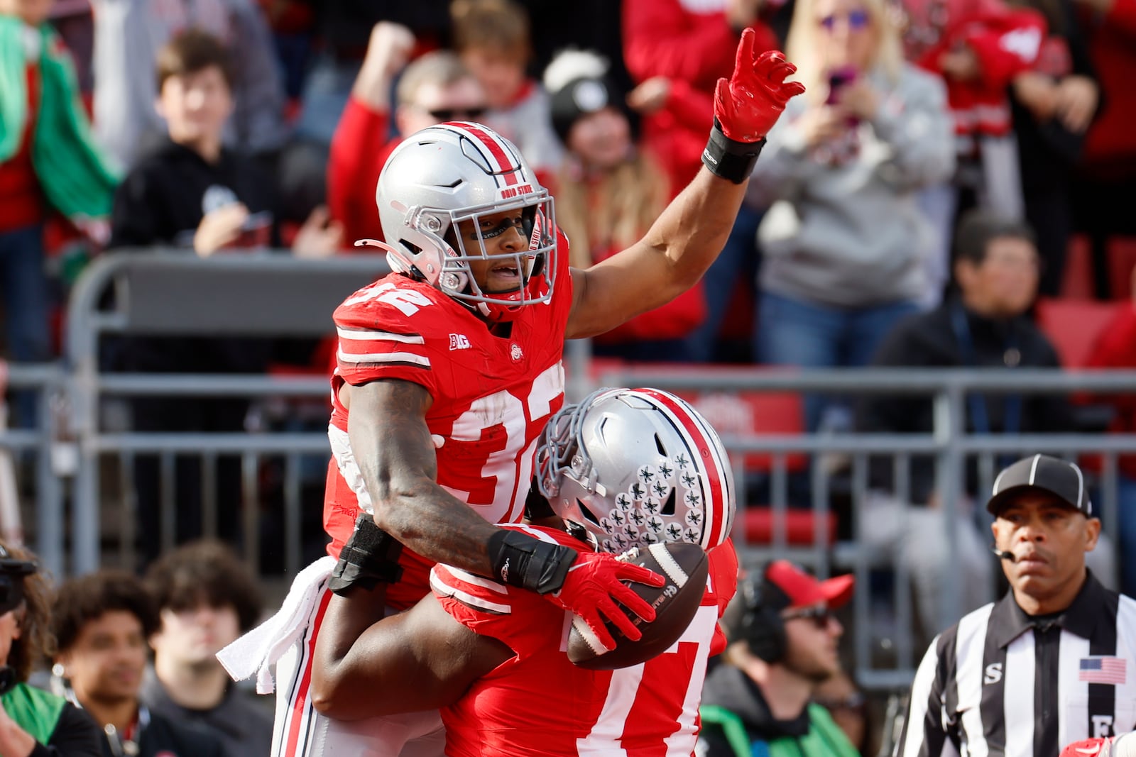 Ohio State running back TreVeyon Henderson, top, celebrates with teammate offensive lineman Tegra Tshabola after scoring a touchdown against Purdue in the second half of an NCAA college football game Saturday, Nov. 9, 2024, in Columbus, Ohio. (AP Photo/Jay LaPrete)