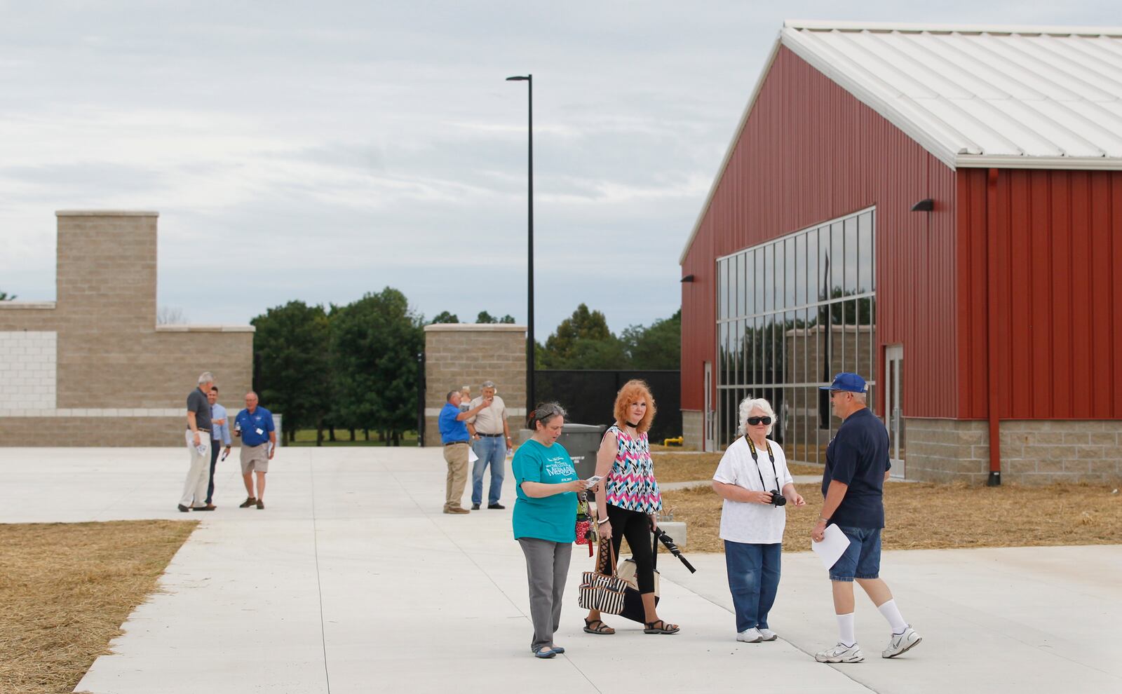 Tom Hoffman, the Montgomery County Fair's hog barn director, gives Karla Giese, Patti Coffee Bouslog and Ann Coffee Ruppert a tour of the new Montgomery County Fairgrounds & Expo Center in Jefferson Twp. on Monday, July 26, 2018. CHRIS STEWART / STAFF