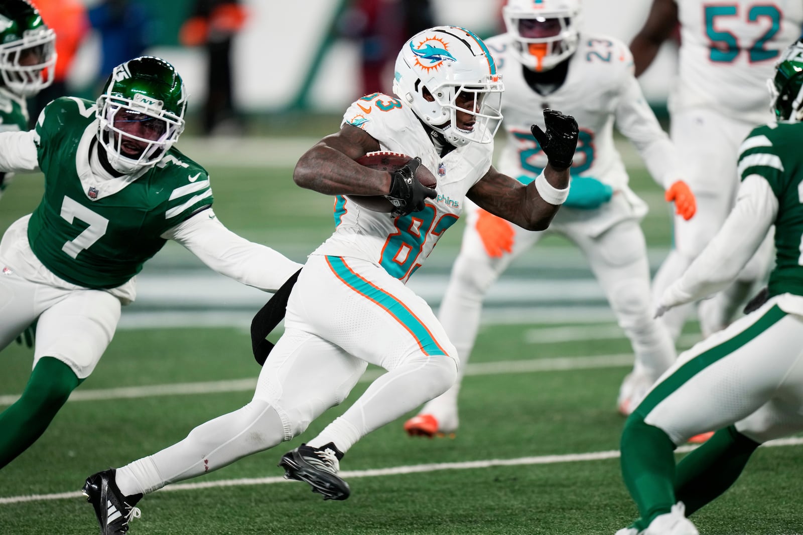 Miami Dolphins wide receiver Malik Washington, center, runs the ball during the second half of an NFL football game against the New York Jets, Sunday, Jan. 5, 2025, in East Rutherford, N.J. (AP Photo/Seth Wenig)