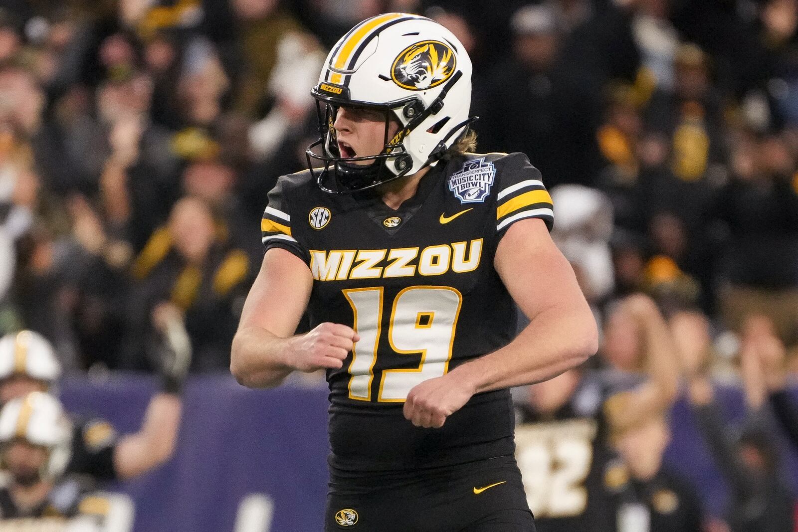 Missouri place-kicker Blake Craig (19) celebrates a 56 yard field goal during the second half of the Music City Bowl NCAA college football game against Iowa, Monday, Dec. 30, 2024, in Nashville, Tenn. Missouri won 27-24. (AP Photo/George Walker IV)