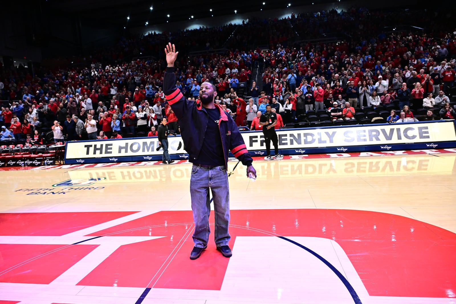 Former University of Dayton basketball great Scoochie Smith acknowledges the crowd at halftime Saturday's game at UD Arena. Smith was inducted into the UD Athletic Hall of Fame. Erik Schelkun/UD Athletics photo