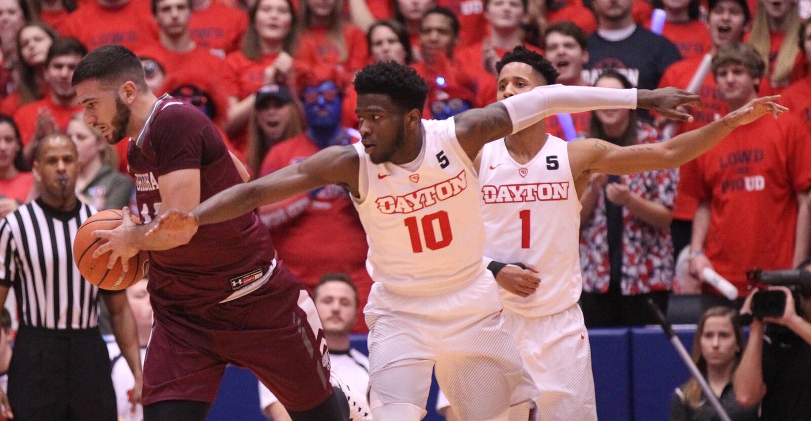 Fordham’s Joseph Chartouny, left, grabs a rebound against Dayton’s Jalen Crutcher on Saturday, Feb. 17, 2018, at UD Arena. David Jablonski/Staff