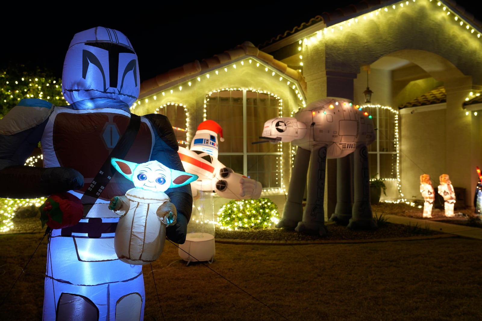 A Star Wars illuminated theme decorate the front lawn of a home in a neighborhood in Mesa, Ariz., Thursday, Dec. 12, 2024, in Mesa, Ariz. (AP Photo/Ross Franklin)