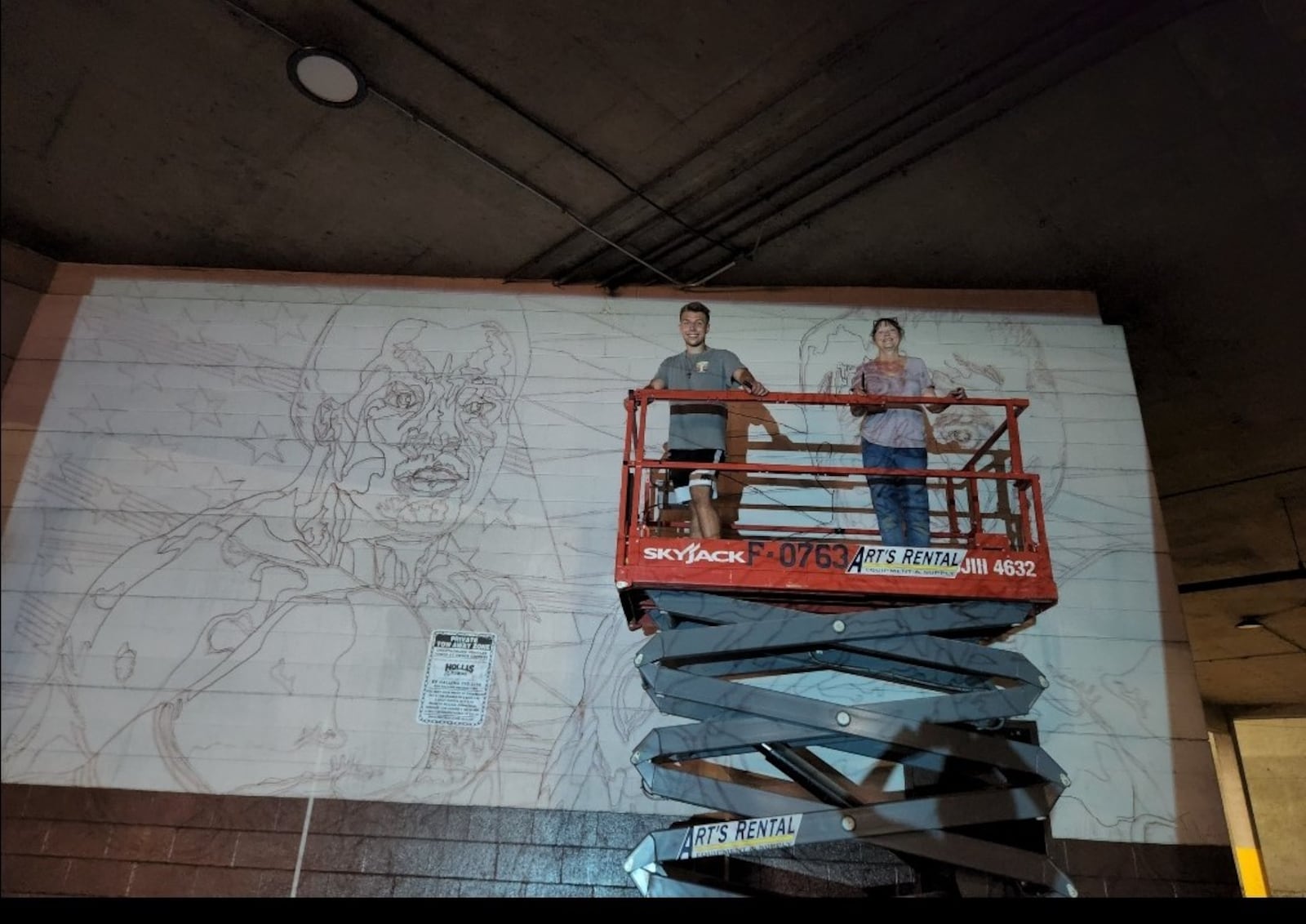 Jackson Stanard (left) and Gae Helton on scaffold putting mural on side of Drake’s Downtown Gym. He’s a UD Student and Flyers boxer and the artist who drew the mural and did much of the work putting it on wall at Drakes. He’s a cruiserweight on the newly former UD boxing team. CONTRIBUTED