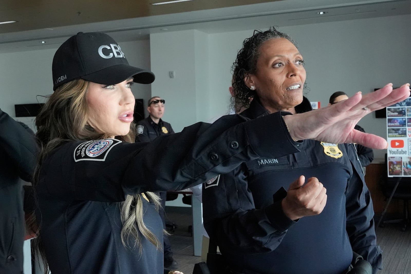 Homeland Security Secretary Kristi Noem, left, tours the San Ysidro Port of Entry, Sunday, March 16, 2025, in San Diego. (AP Photo/Alex Brandon)