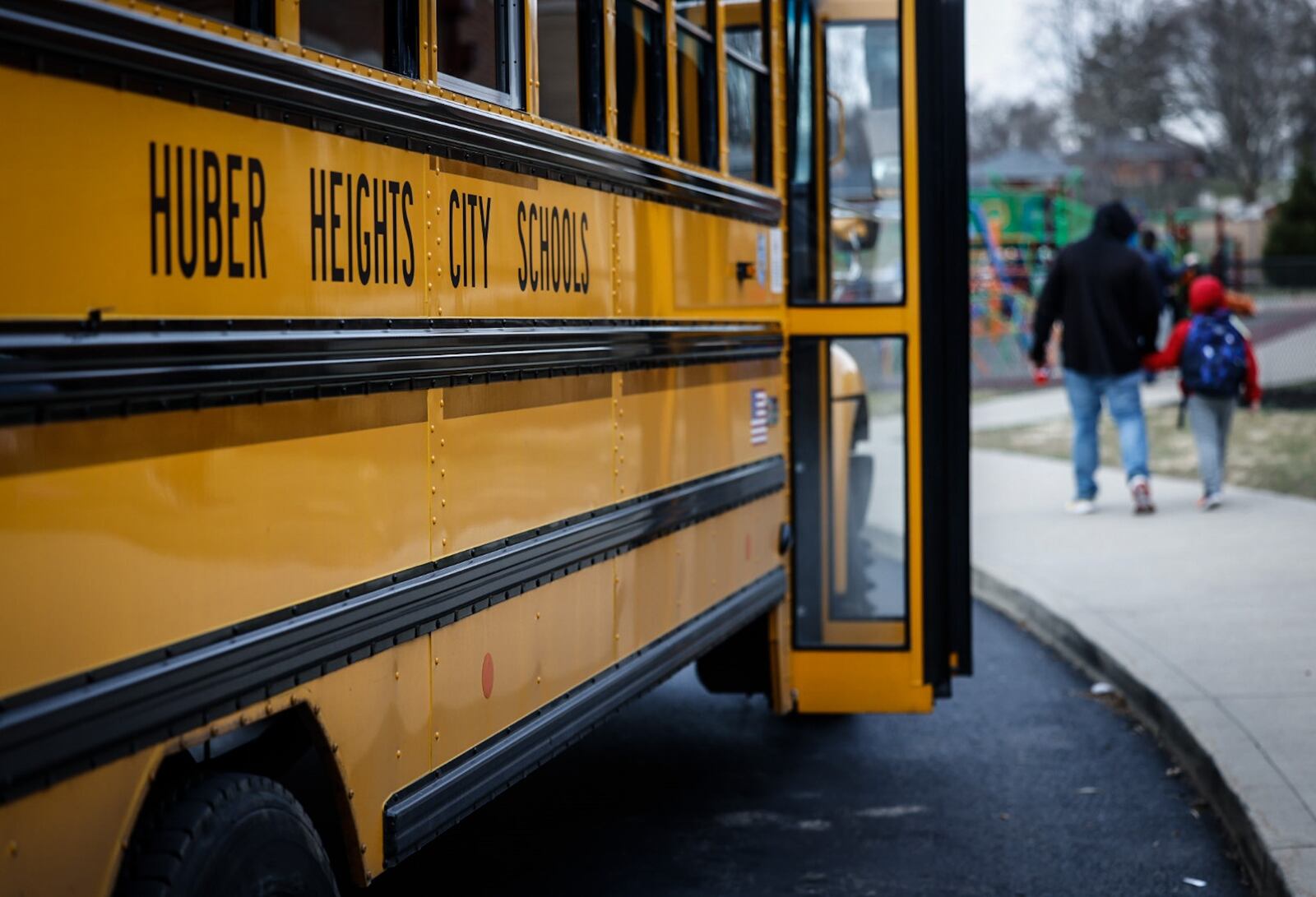 Students at Wright Brothers Elementary head to the bus for a ride home Tuesday December 13, 2022. Schools across the region are still struggling to cover bus routes including Huber Heights schools. JIM NOELKER/STAFF