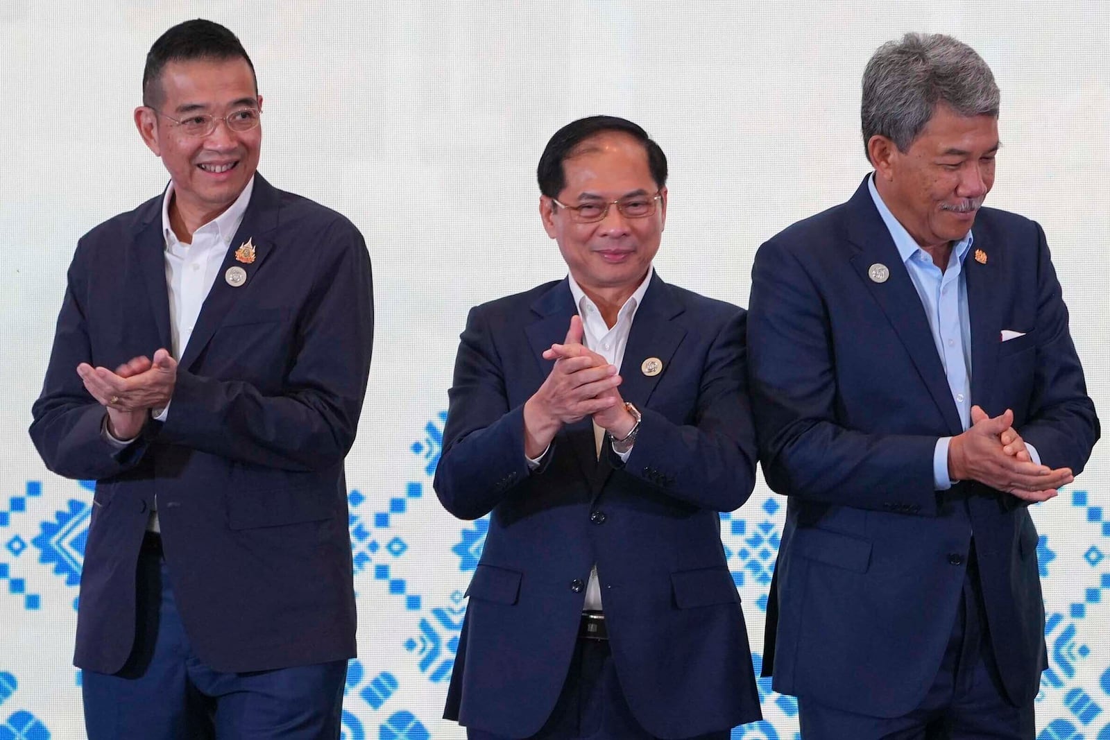 From left to right, Thailand's Minister of Foreign Affairs Maris Sangiampongsa, Vietnam's Deputy Prime Minister and Minister of Foreign Affairs Bui Thanh Son and Malaysia's Minister of Foreign Affairs Mohamad Hasan clap after a group photo session during the ASEAN Foreign Ministers' Retreat (AMM) in Langkawi Island, Malaysia, on Sunday, Jan. 19, 2025. AP Photo/Azneal Ishak, Pool)