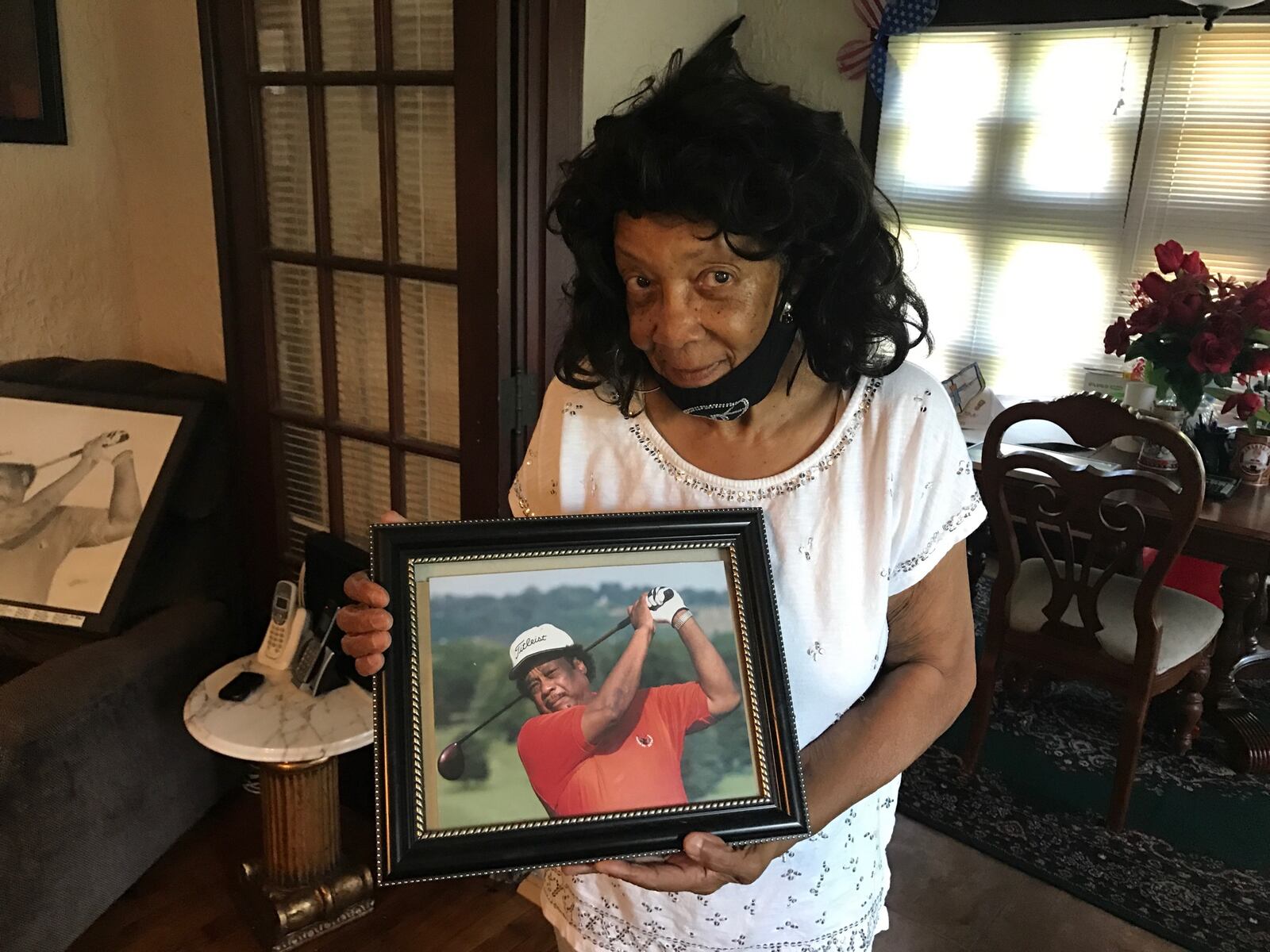 Margaret Brown holds a photo of her late husband Pete Brown in her Dayton View home on Saturday, Aug. 15, 2020. Tom Archdeacon/STAFF