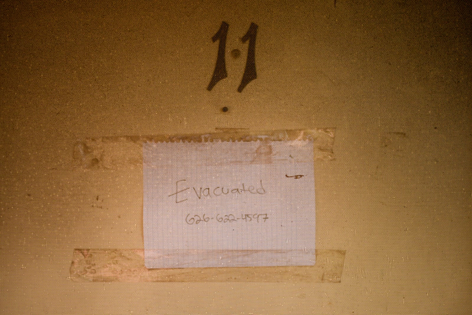 A sign is left at the entrance to an apartment after the Eaton Fire Friday, Jan. 17, 2025 in Altadena, Calif. (AP Photo/Jae C. Hong)