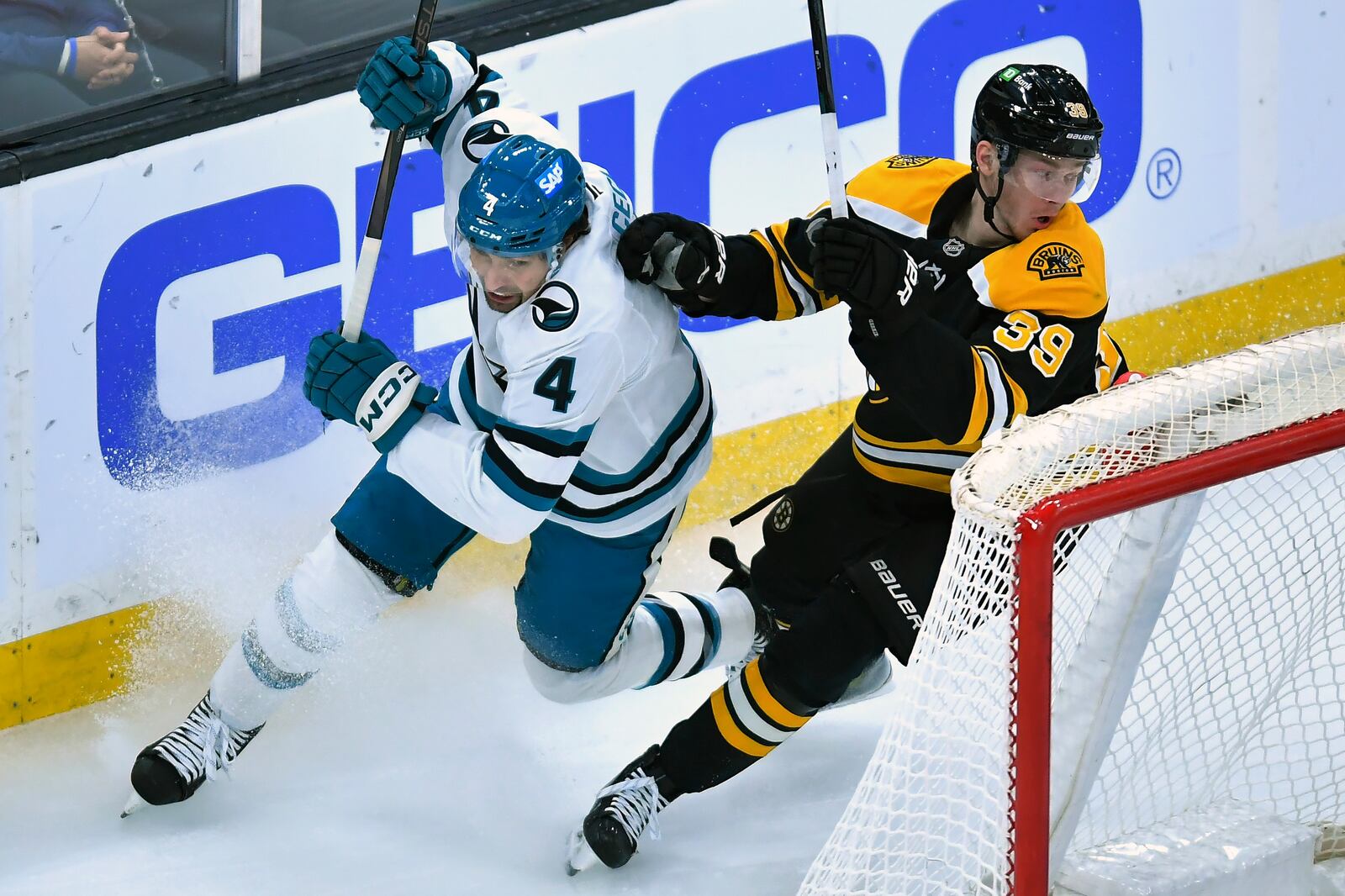 San Jose Sharks defenseman Cody Ceci (4) and Boston Bruins center Morgan Geekie (39) vie for position in the second period of an NHL hockey game, Monday, Jan. 20, 2025, in Boston. (AP Photo/Steven Senne)