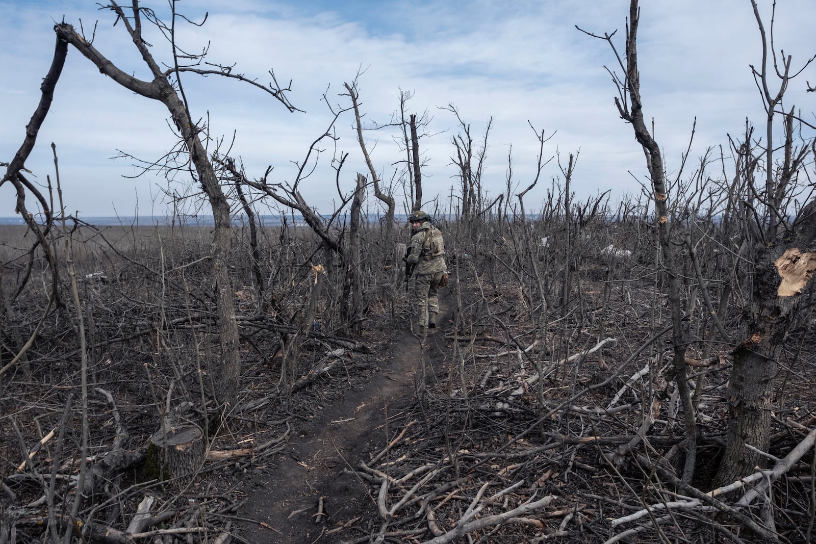 FILE - A Ukrainian soldier walks near Klishchyivka, Donetsk region, Ukraine, Monday, March 18, 2024. (Iryna Rybakova via AP, File)