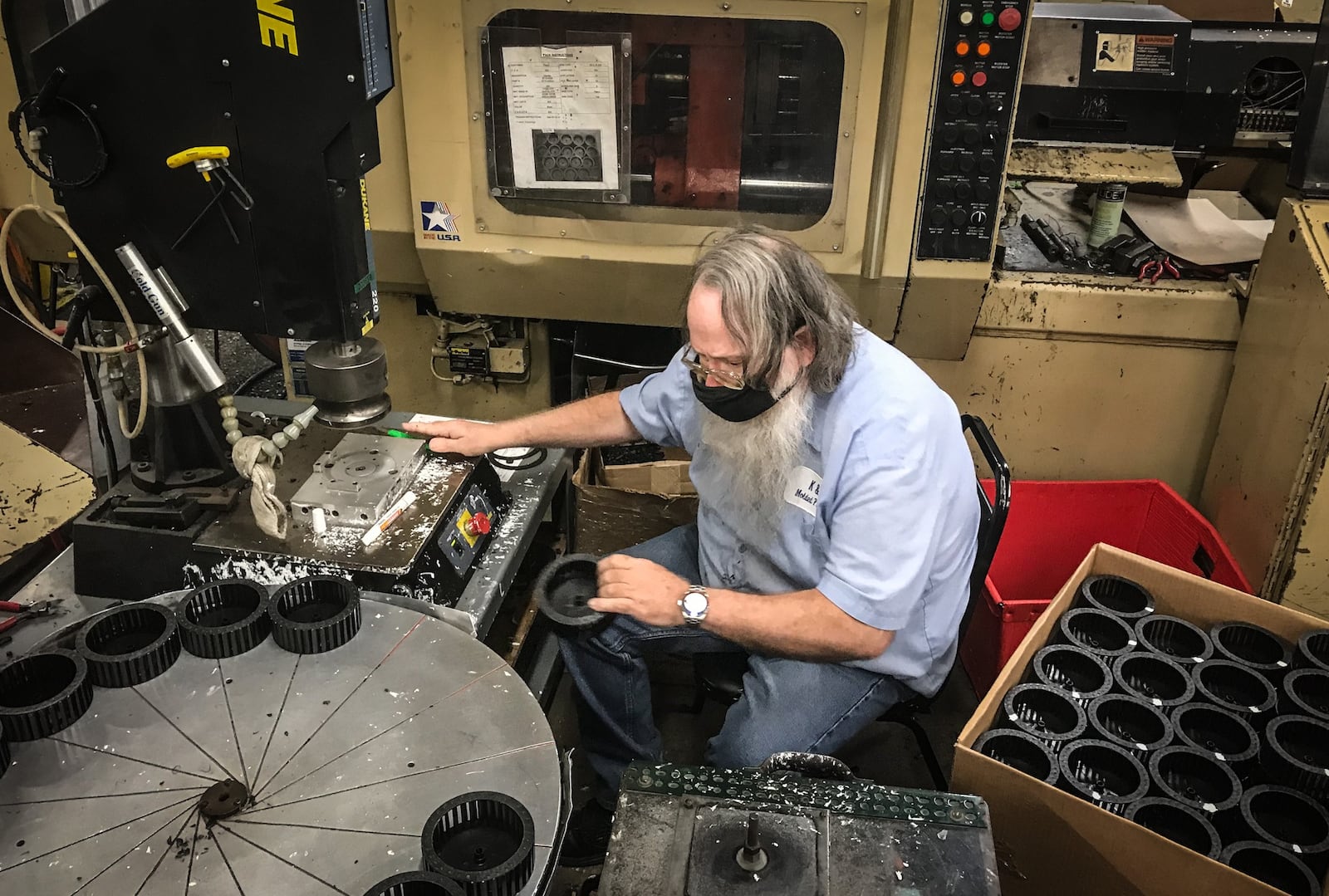 Operator Mark Schrum works on a injection mold machine at K&B Molded Products. Workers at K&B Molded Products of Clay Township work three shifts to keep up with demand for their injection mold products. The company is having a hard time filling production jobs.