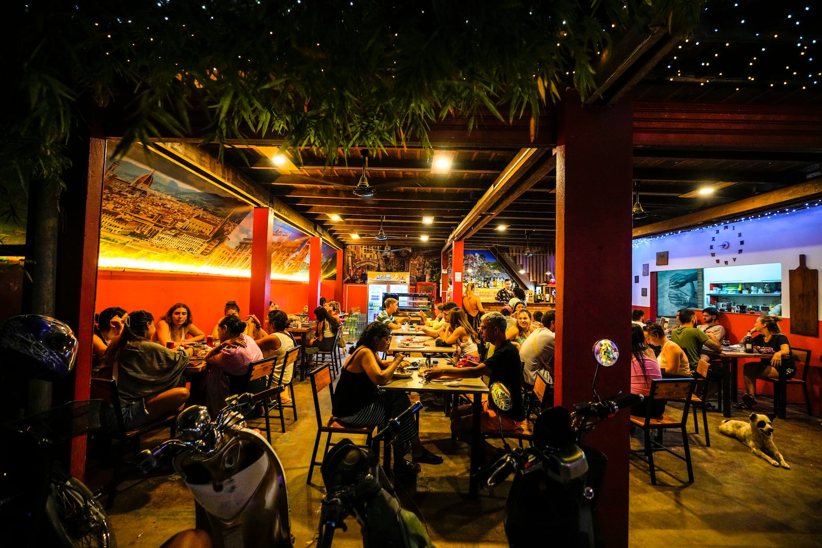 Foreign tourists have a drink at a night club at Nana Backpack hostel in Vang Vieng, Laos, Tuesday, Nov. 19, 2024. (AP Photo/Anupam Nath)