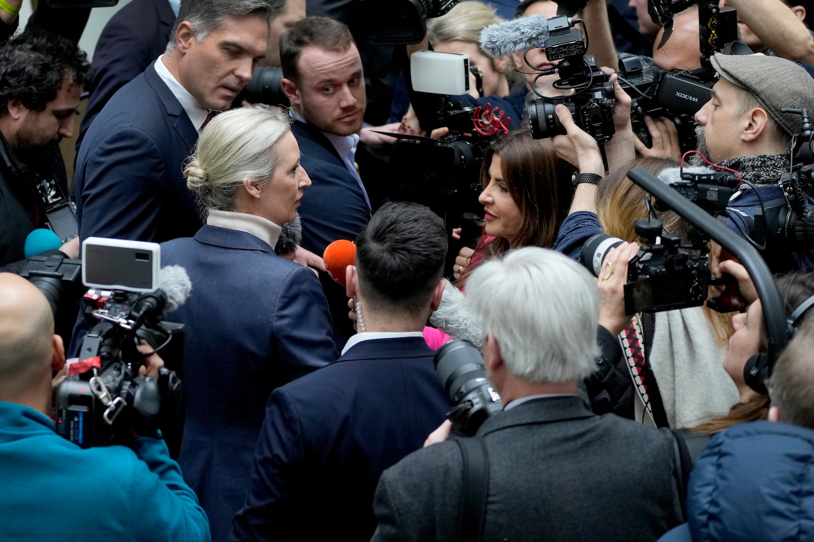 Alice Weidel, centre left, co-leader of the Alternative for Germany Party (AfD), is surrounded by journalists after a press conference in Berlin, Germany, Monday, Feb. 24, 2025, the day after the national election. (AP Photo/Michael Prost)