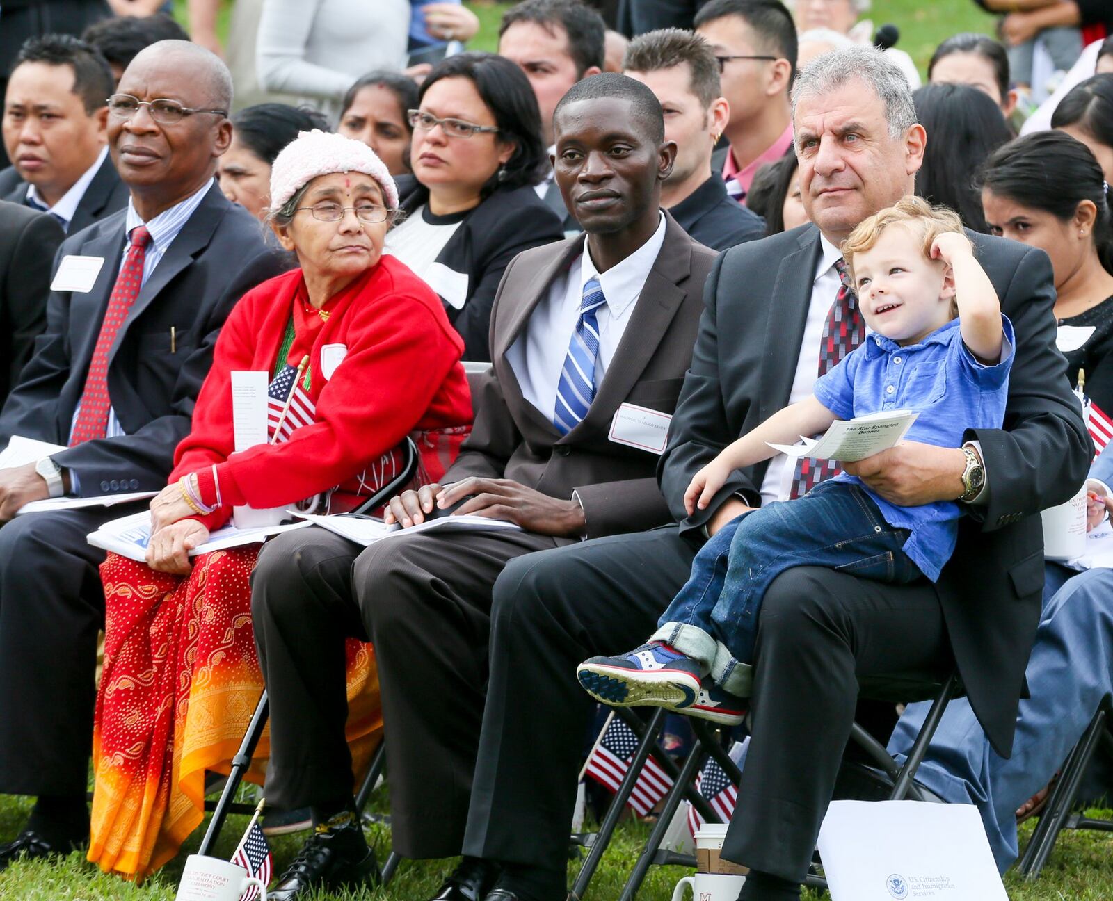 Abraham Kajomovitz, from Mexico City, sits with his grandson, Adam Kerbel, as he participates in a naturalization ceremony held at Miami University Hamilton, Thursday, Sept. 14, 2017. GREG LYNCH / STAFF