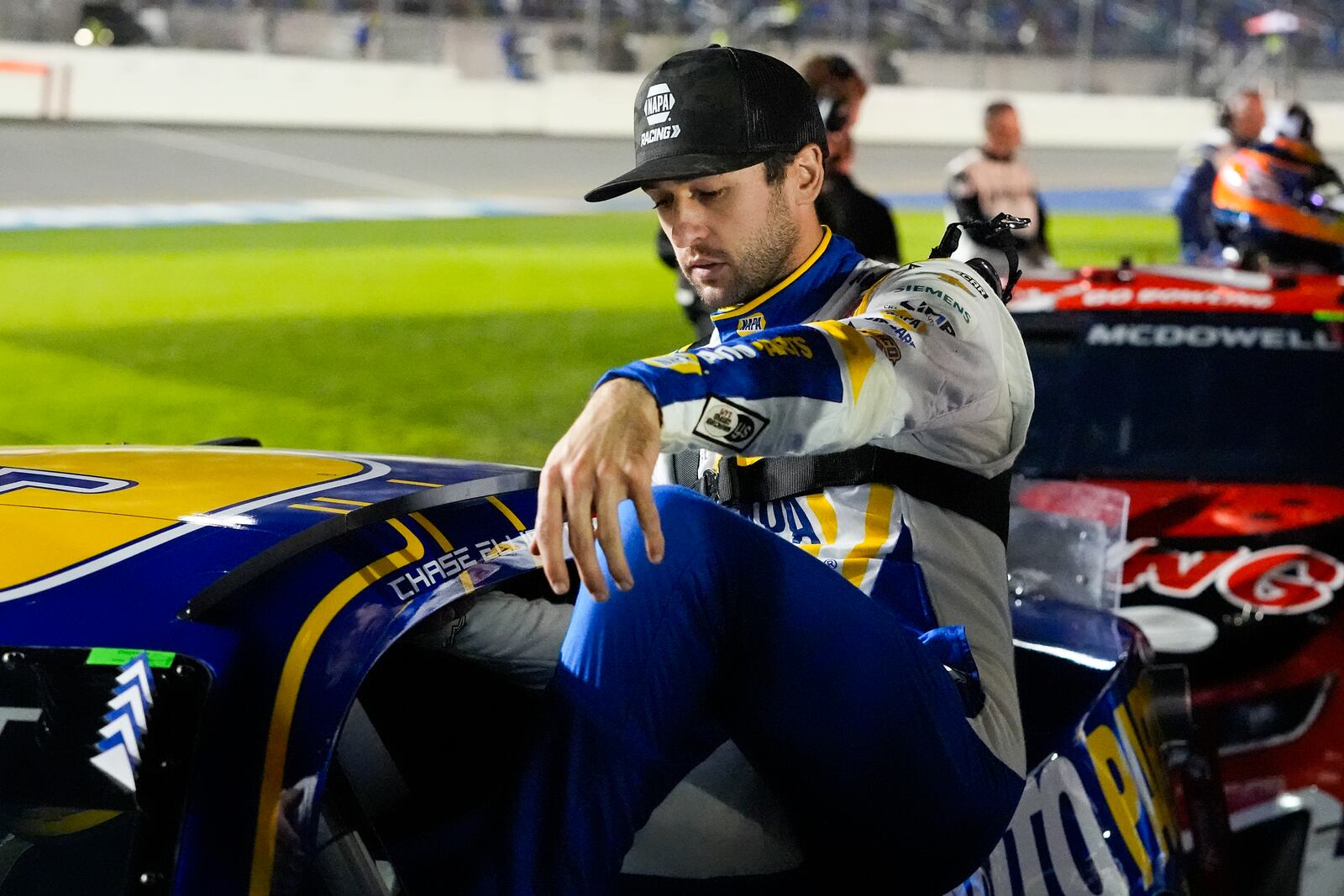 Chase Elliott climbs in his car preparing for the start of the first of two NASCAR Daytona 500 qualifying auto races at Daytona International Speedway, Thursday, Feb. 13, 2025, in Daytona Beach, Fla. (AP Photo/John Raoux)