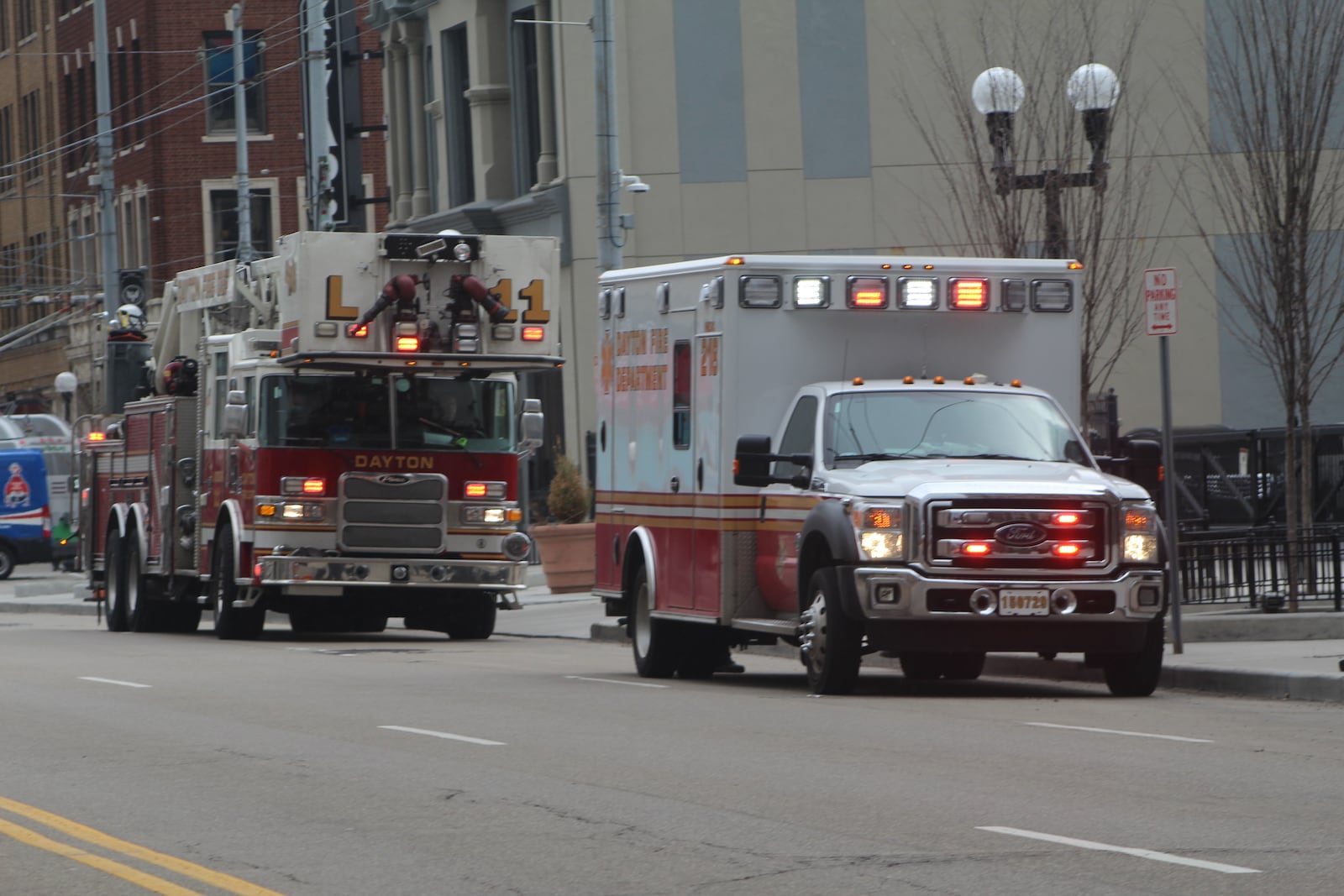 Dayton fire and EMS crews respond to  an incident on East Third Street in downtown Dayton. CORNELIUS FROLIK / STAFF