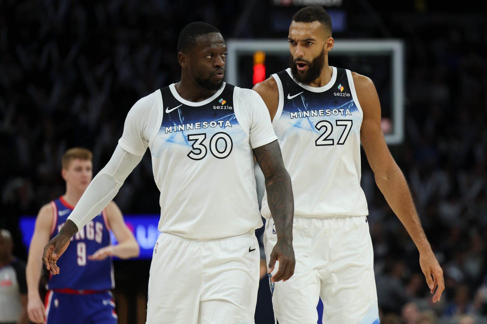 Minnesota Timberwolves forward Julius Randle (30) and center Rudy Gobert (27) react during the second half of an NBA basketball game against the Sacramento Kings, Wednesday, Nov. 27, 2024, in Minneapolis. (AP Photo/Ellen Schmidt)