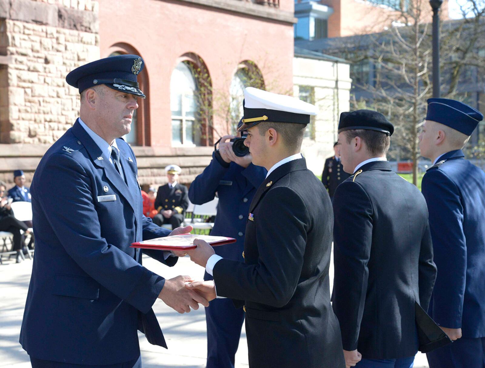 Col. Patrick Miller, 88th Air Base Wing and Wright-Patterson Air Force Base commander, awards Navy ROTC midshipman Colin Patil the Major Lawrence scholarship April 14 at Ohio State University. U.S. AIR FORCE PHOTO/DARRIUS PARKER